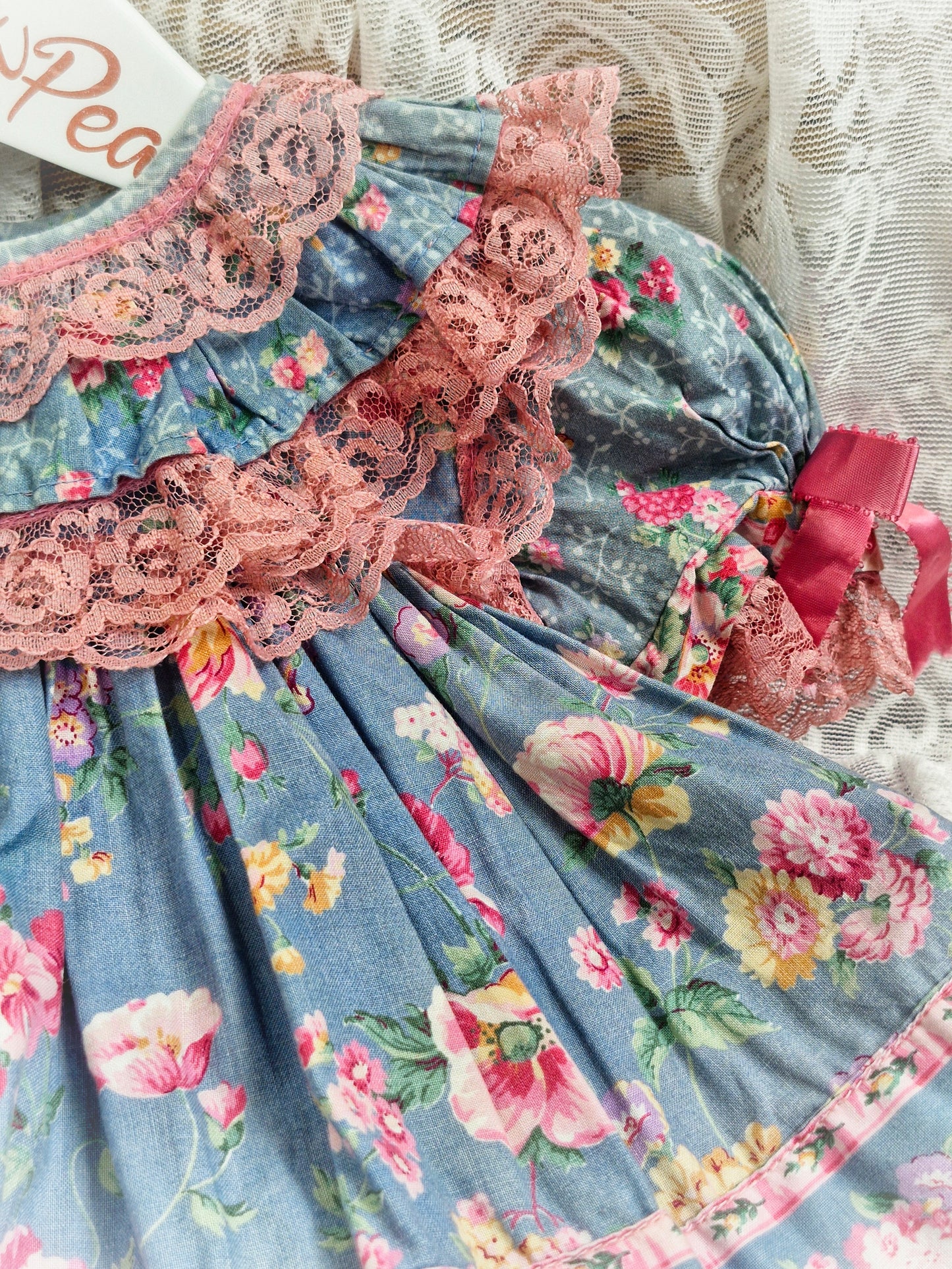 12 months. Blue dress with flowers. Pink lace and ribbons