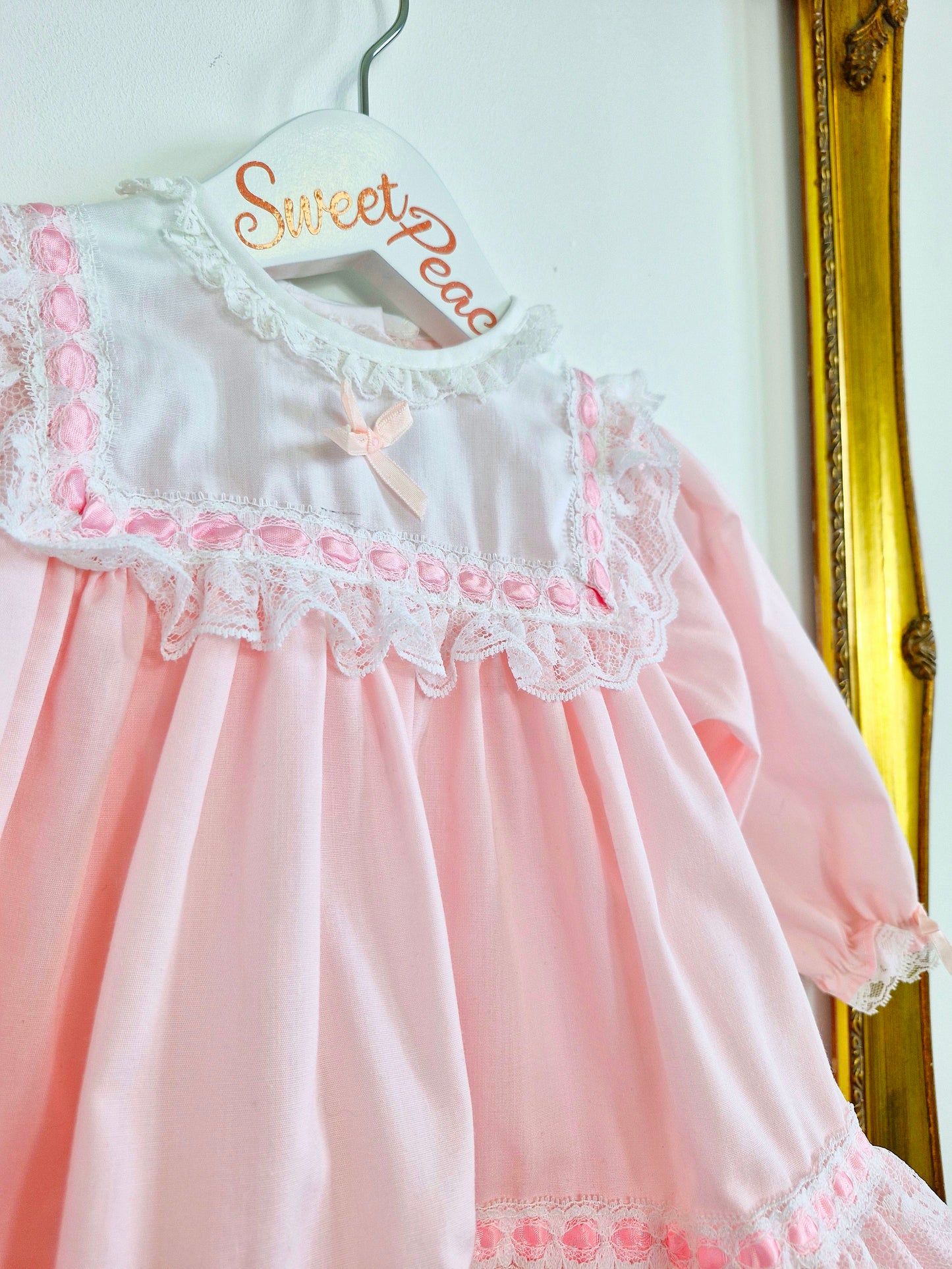 9-12 months. Pink Alexis dress with white bib, lace and ribbon details