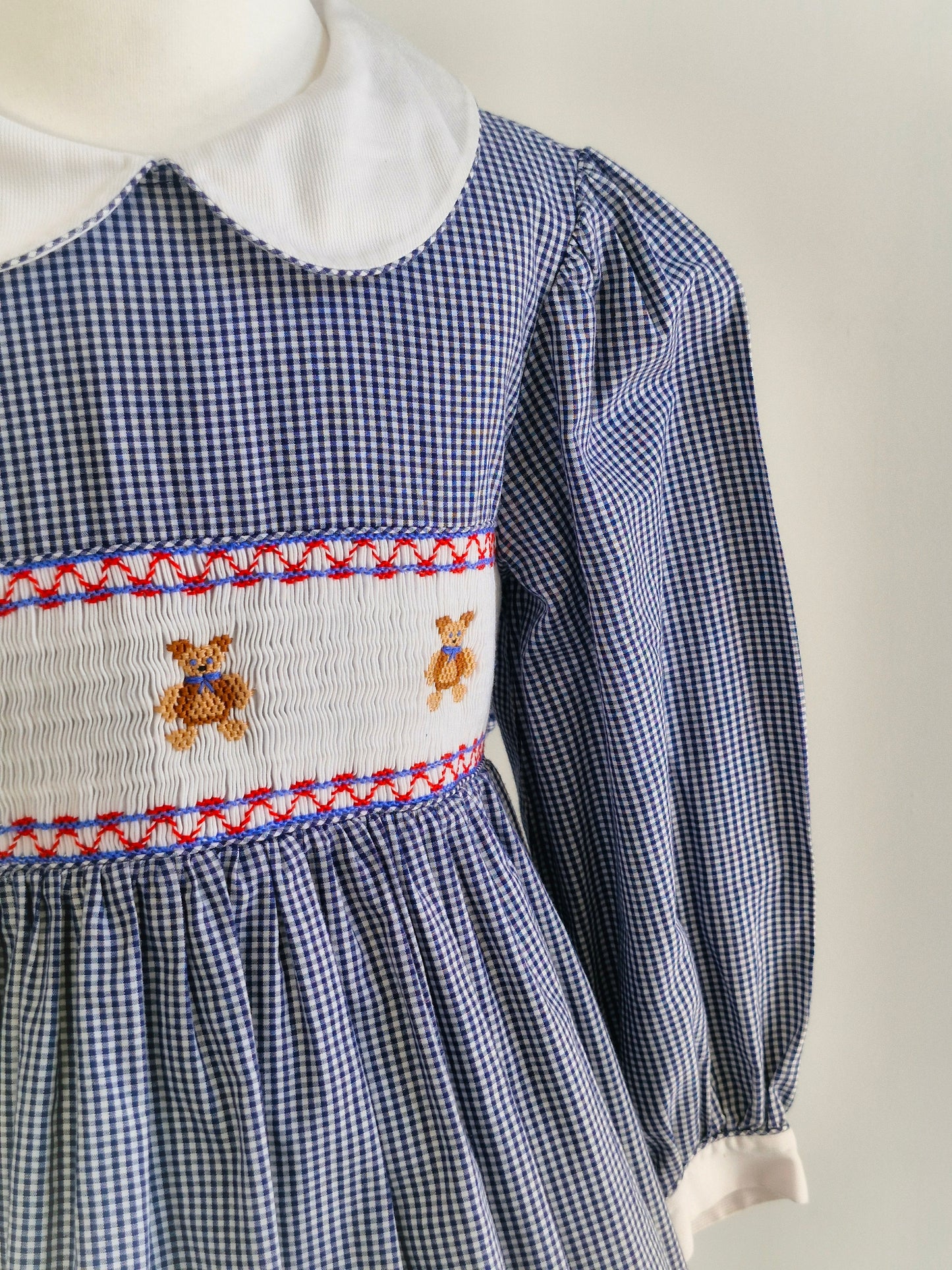 7 years. Navy and white Sweet Angela gingham smock dress with teddies