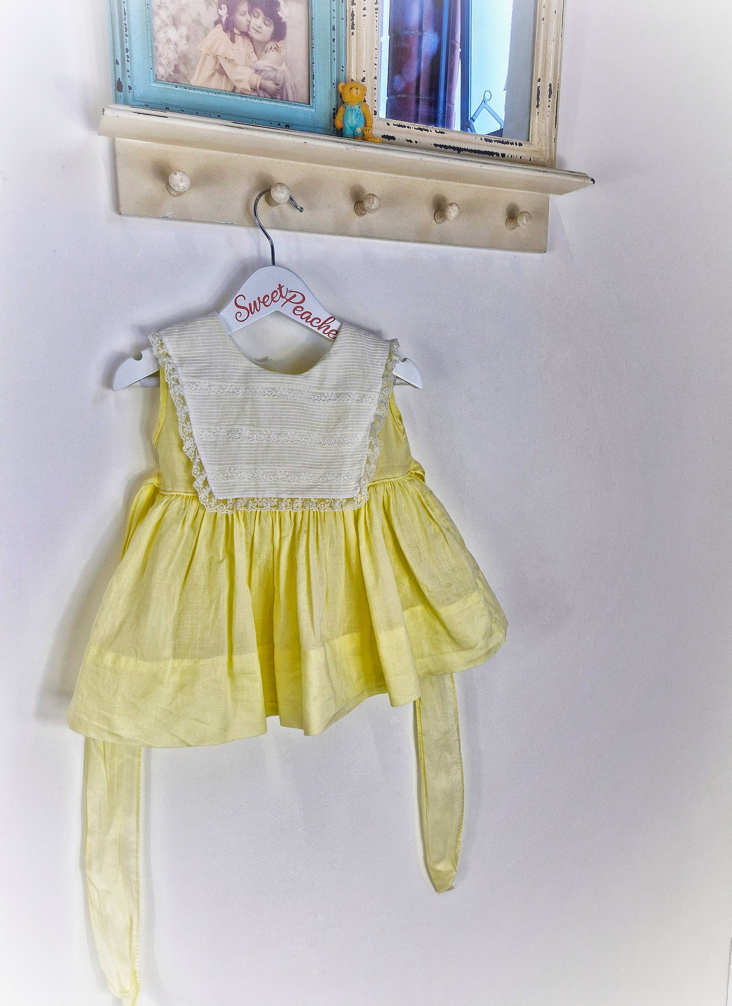 12-18 months. Lemon sleeveless dress with white bib