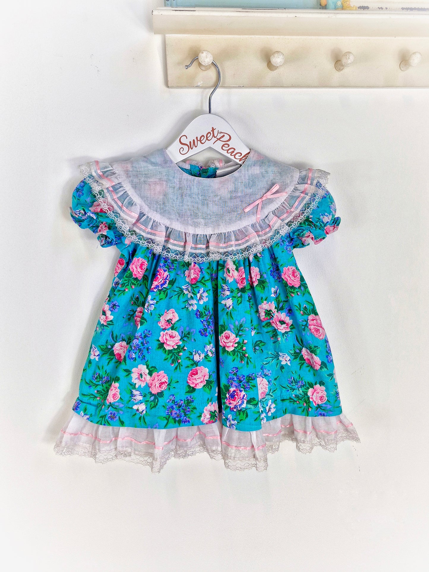 18-24 months. Floral dress from Carters with bib and ribbon details