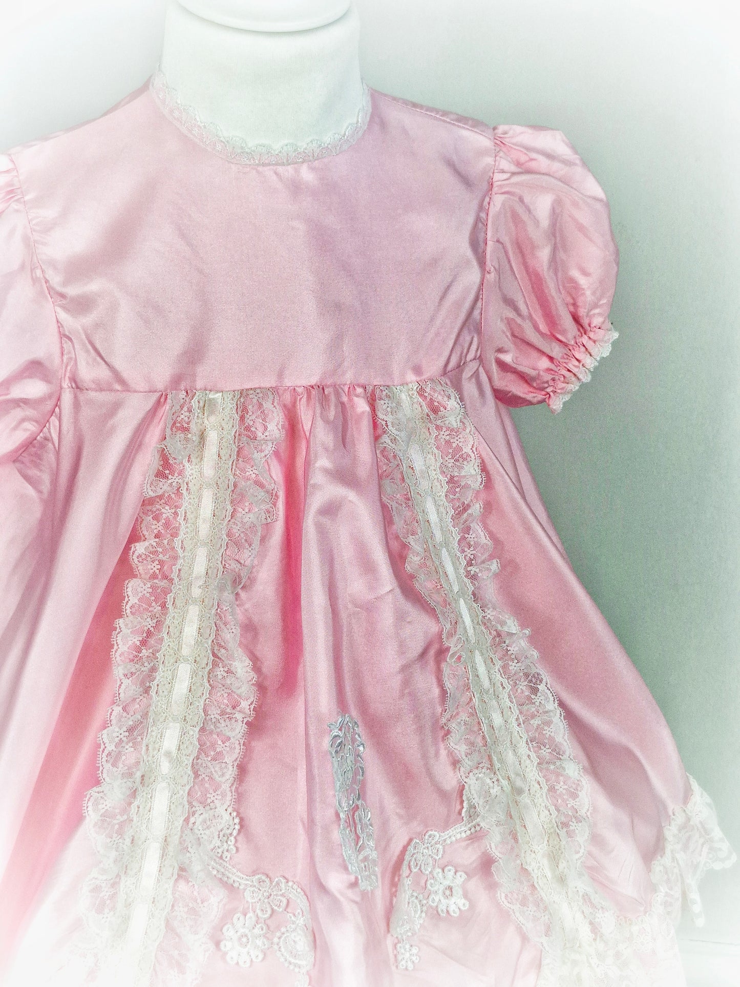 3 years. Pretty pink dress with white lace details