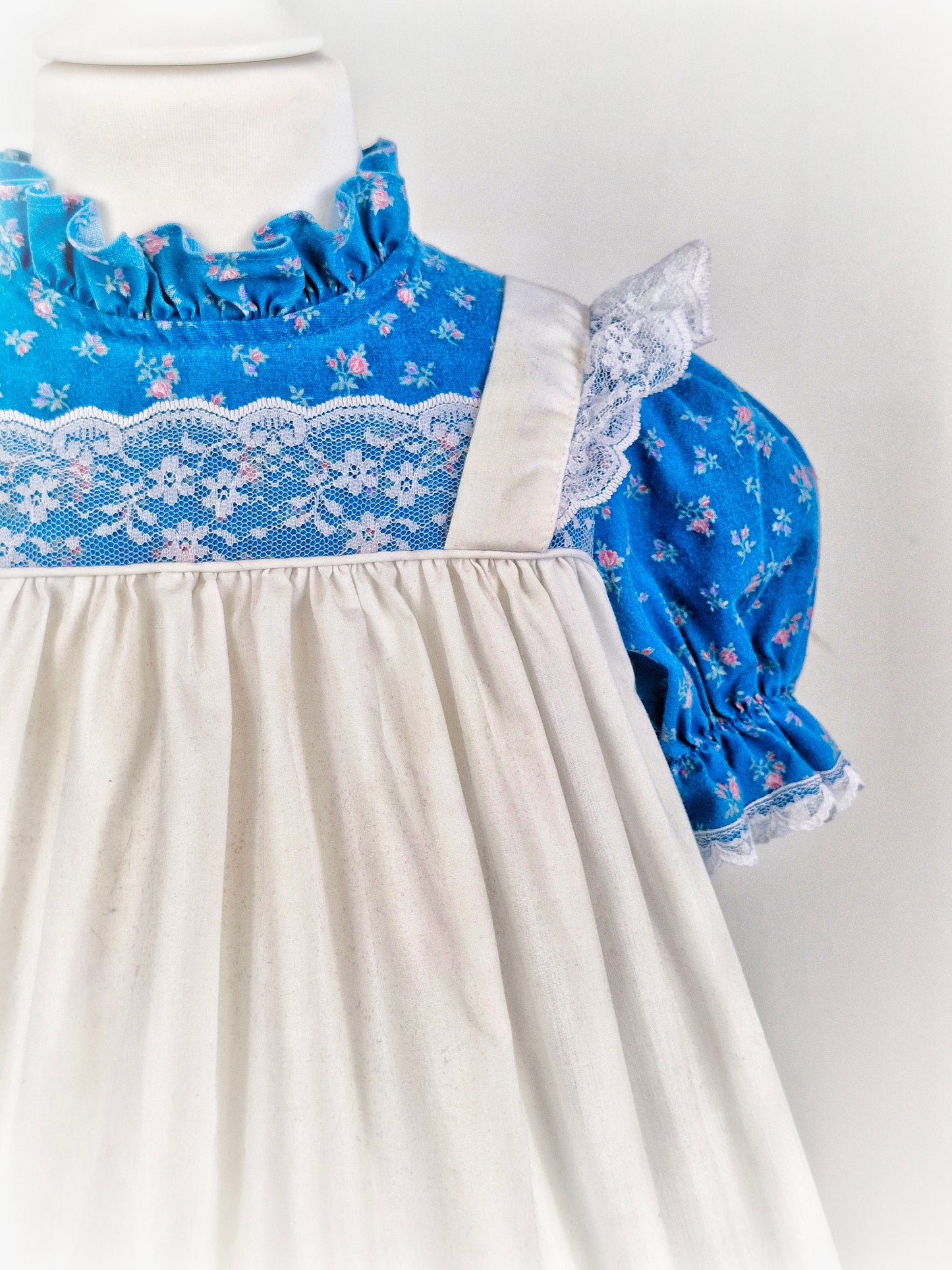 3-4 years. Blue floral Kawalla dress with attached white lace pinny