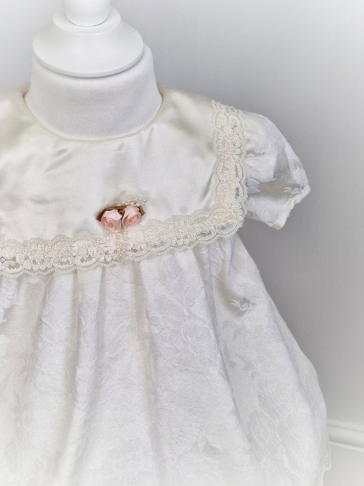 2 years. White Stone Gear dress with flowers, bib, lace and rosette. 1981.