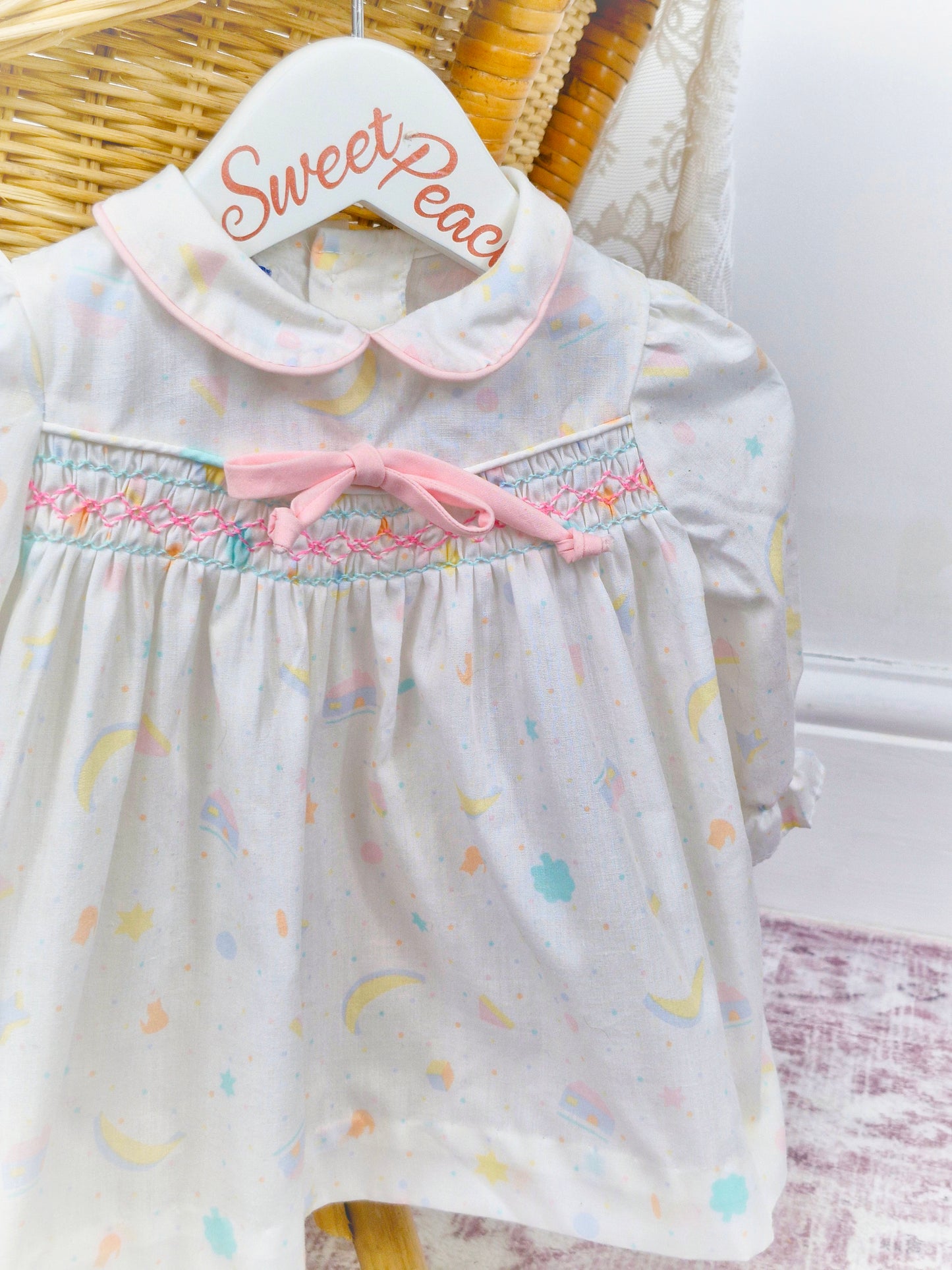 6-9 months. Polly Flinders 1962 smock dress, white with cute print