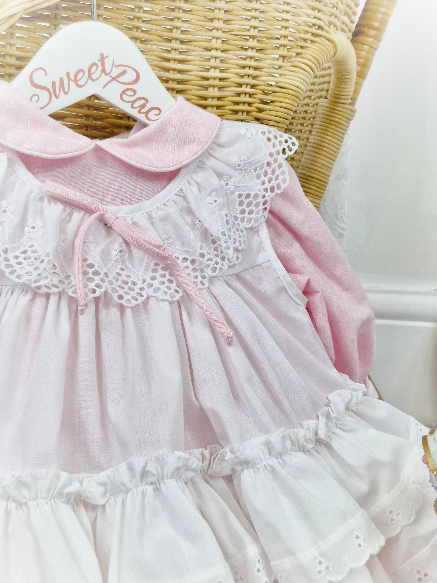 12 months. Pink Bryan dress with white floral print and apron