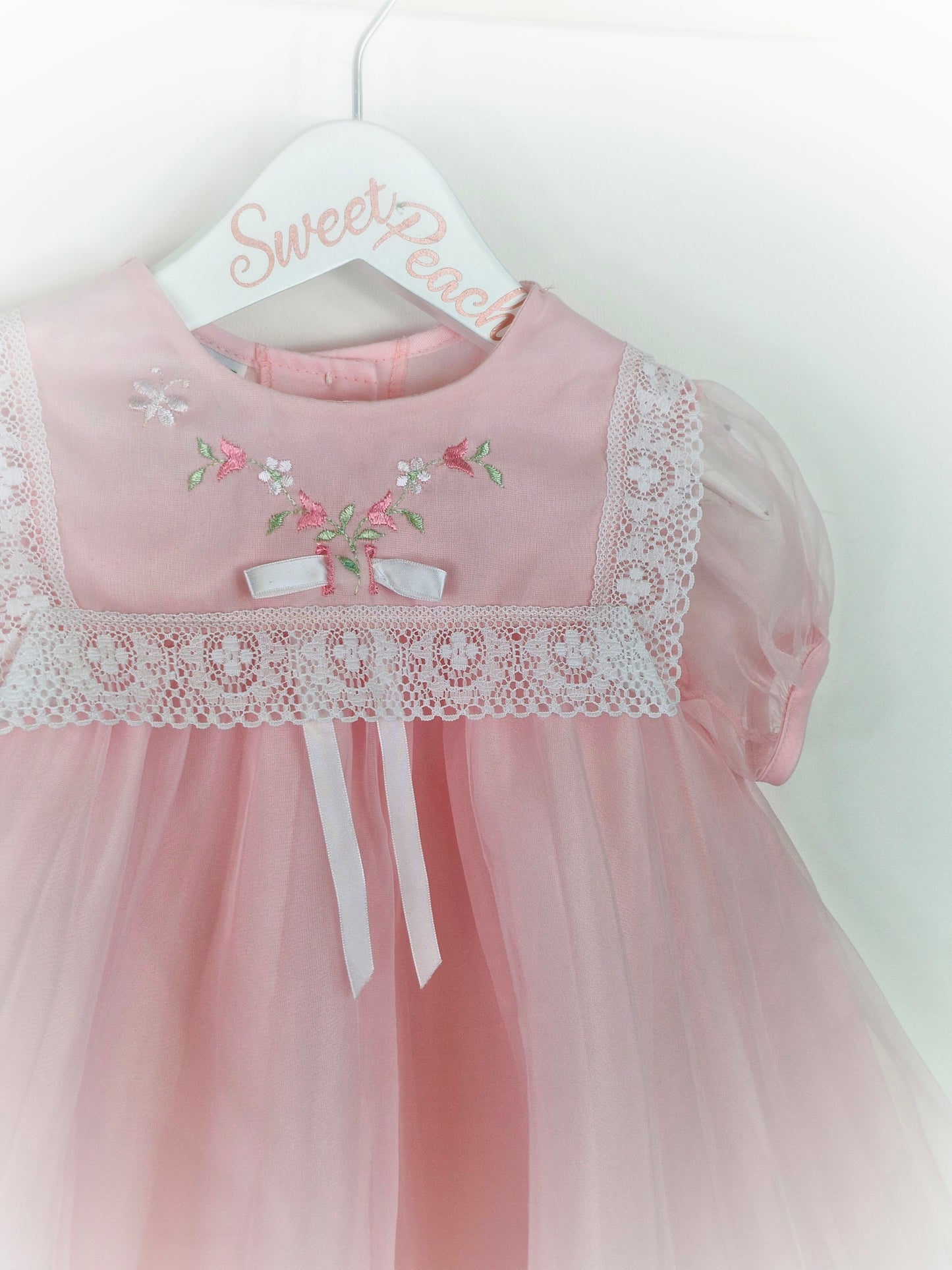 18-24 months. Pink Wildflowers by JC Penney. Lace trim on bib, embroidered with flowers