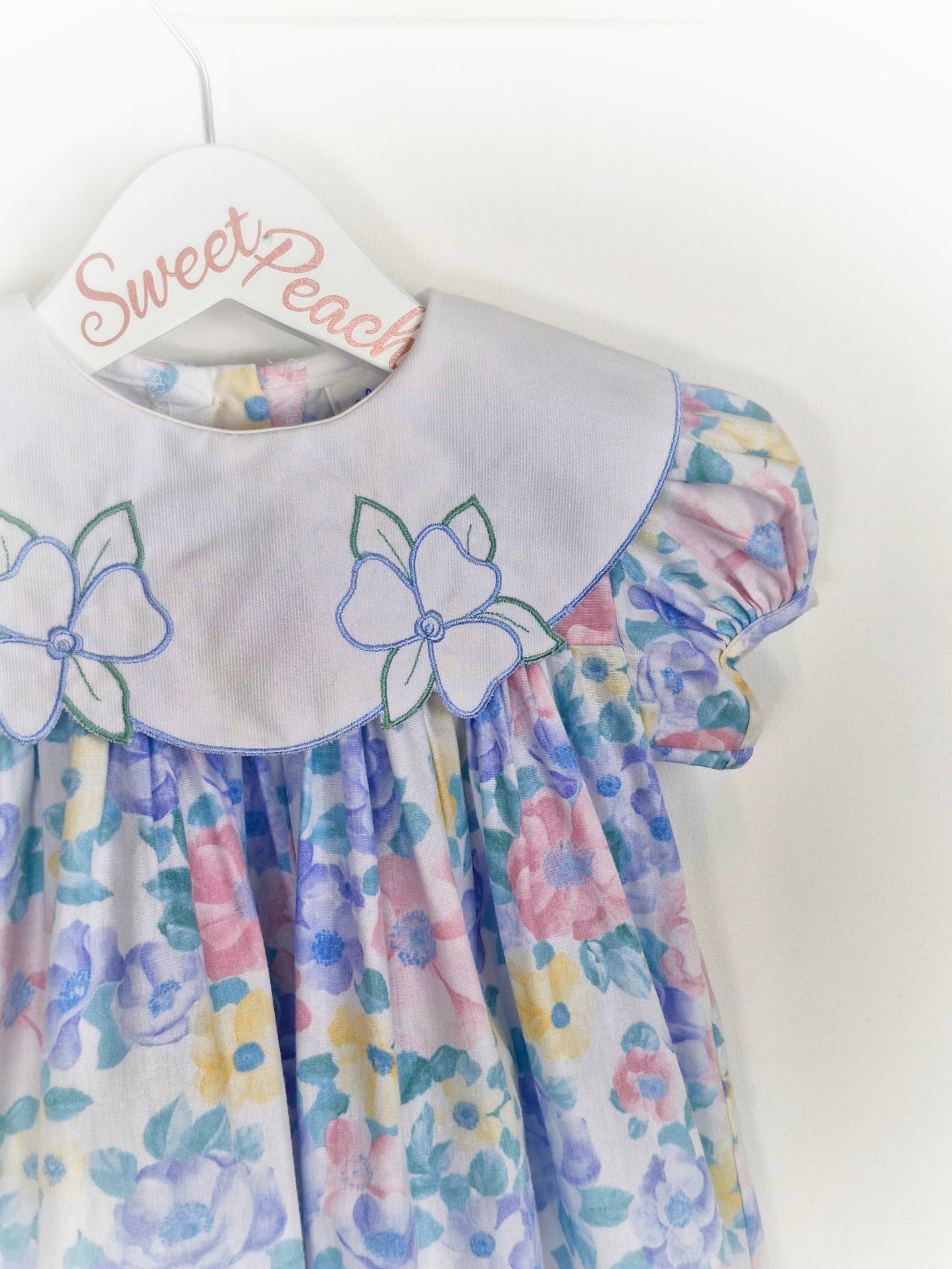 2 years. Pastel Alexis with white embroidered bib
