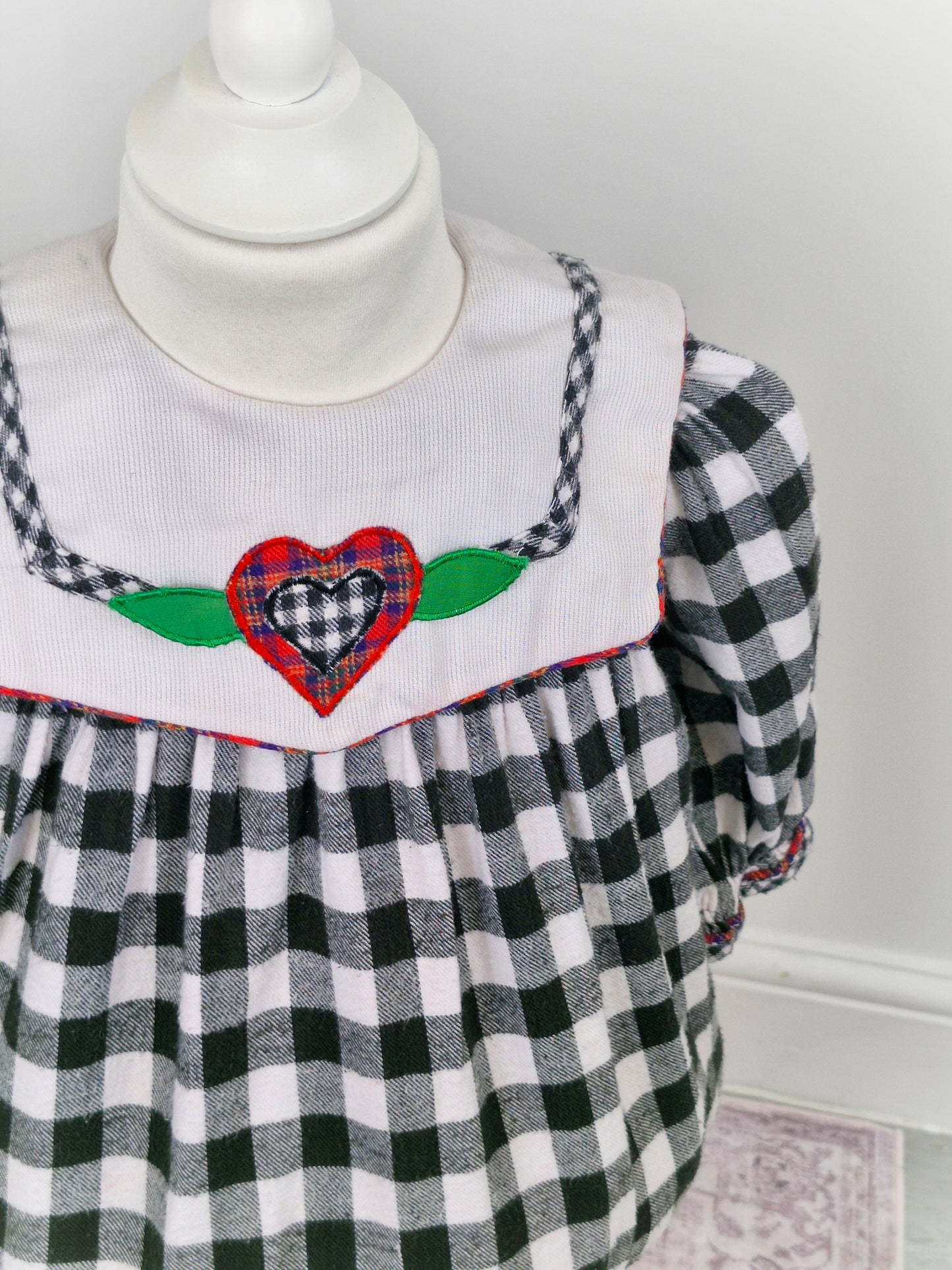 18-24 months. Black and white gingham vintage cradle togs dress with white bib and heart appliqué