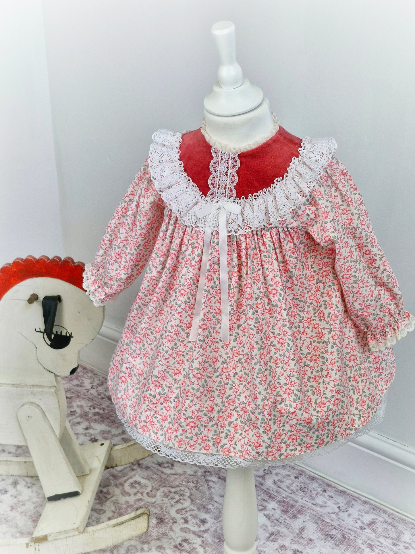 2 years. Red and white floral Bryan with velour top, lace trim and ribbon