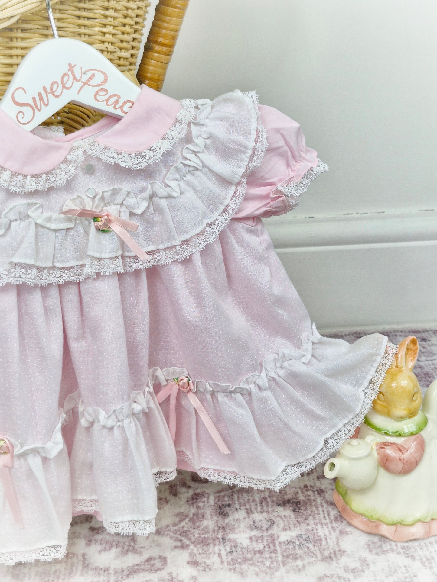 6-9 months. Pink frilly Fayette dress with white, mock pinny