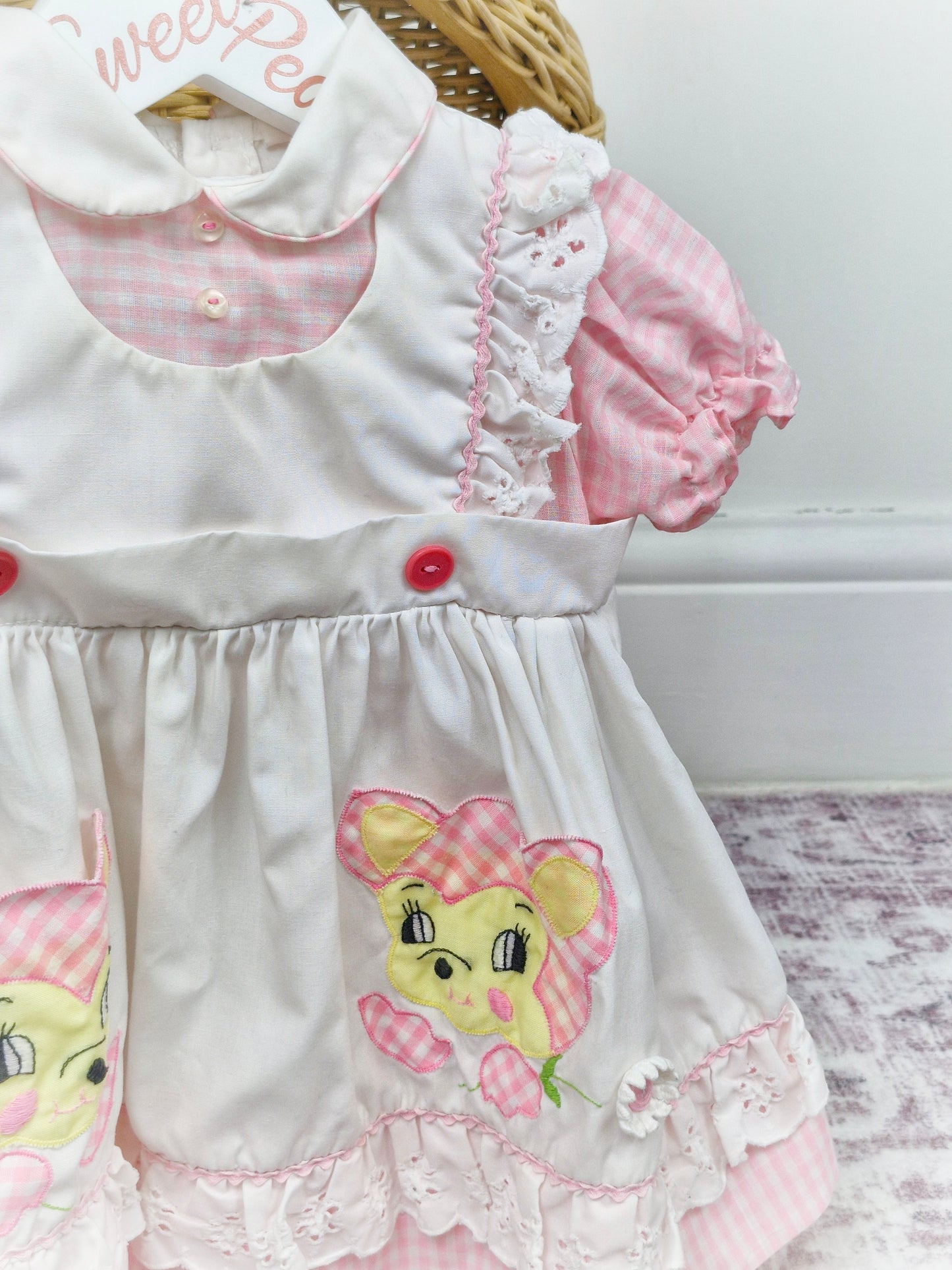 9-12 months. White and pink gingham dress, peter pan collar, pinny style and bear(?) motifs