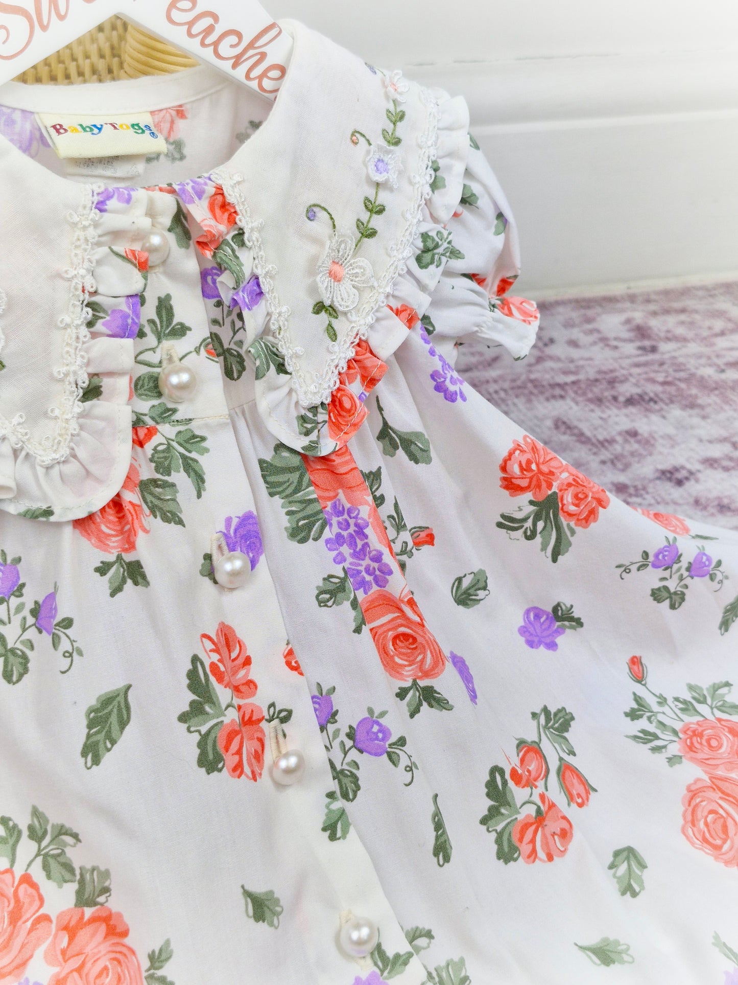 18 months. White dress from Baby Togs with floral print, large embroidered collar and pearl style buttons