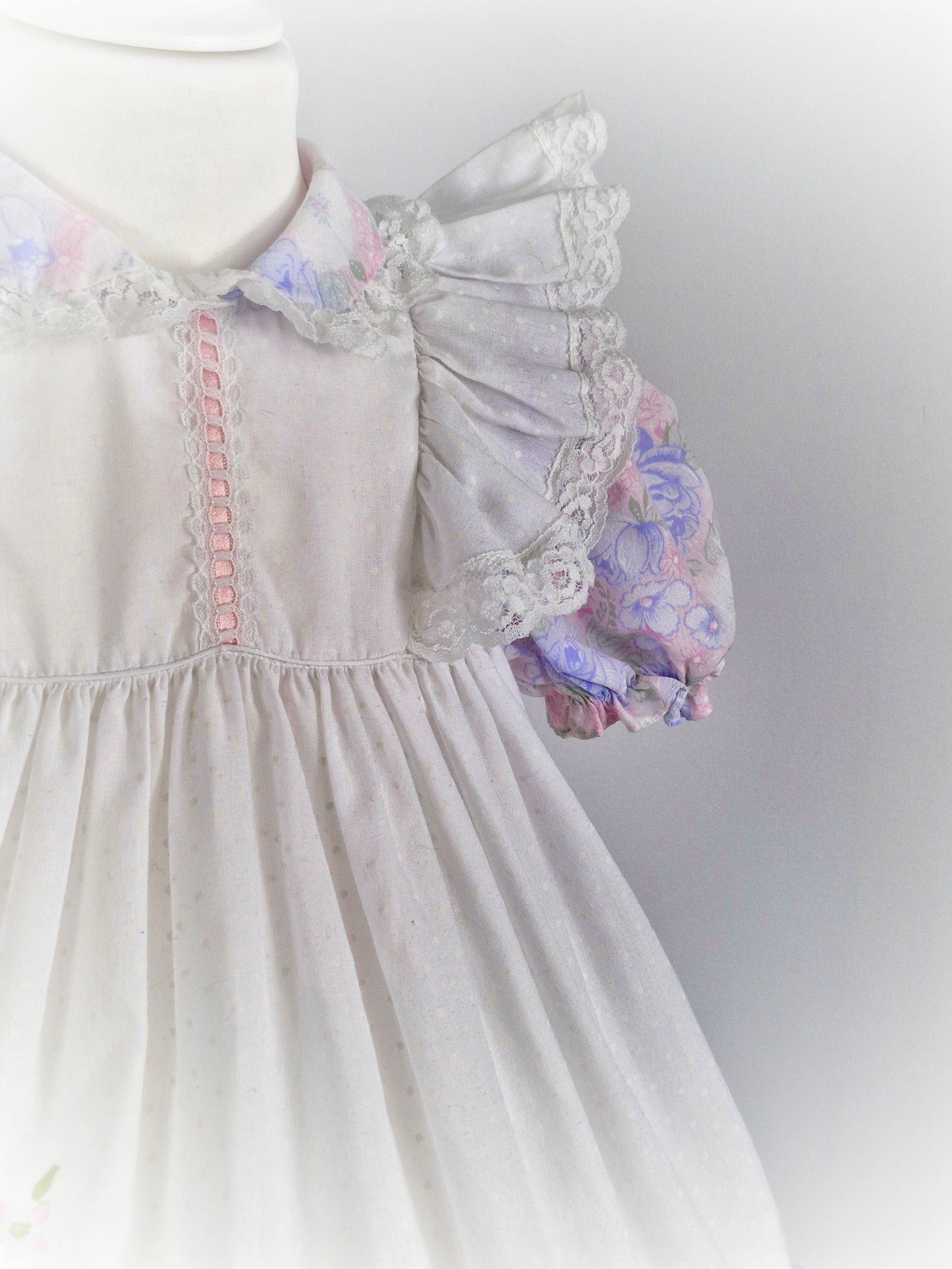3 years. White dress with pastel flutter sleeves and hem. Cherry applique and lace details