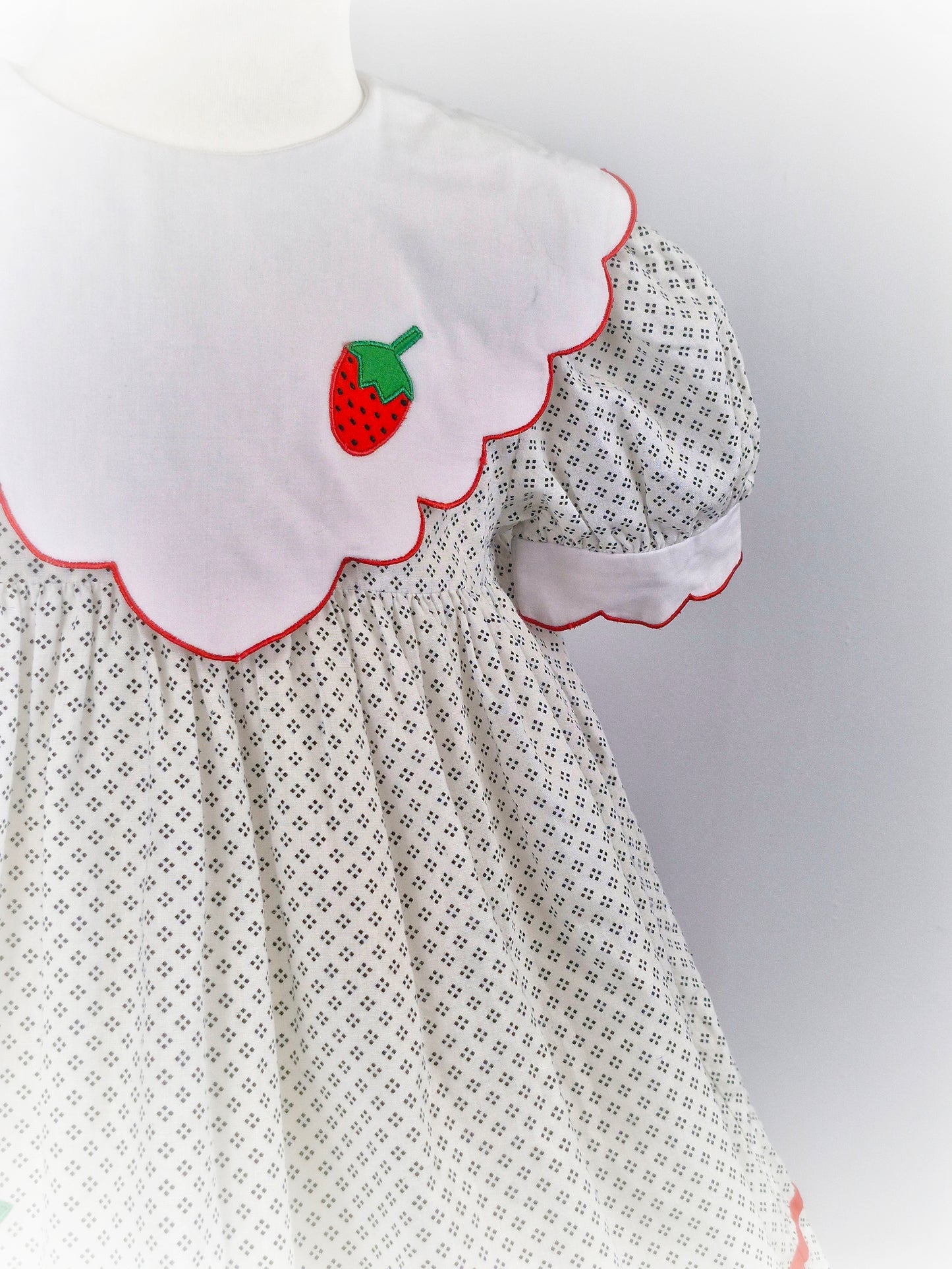 4 years. Vintage strawberry dress, off-white with dot patterns, white scalloped bib and sleeves with red trim