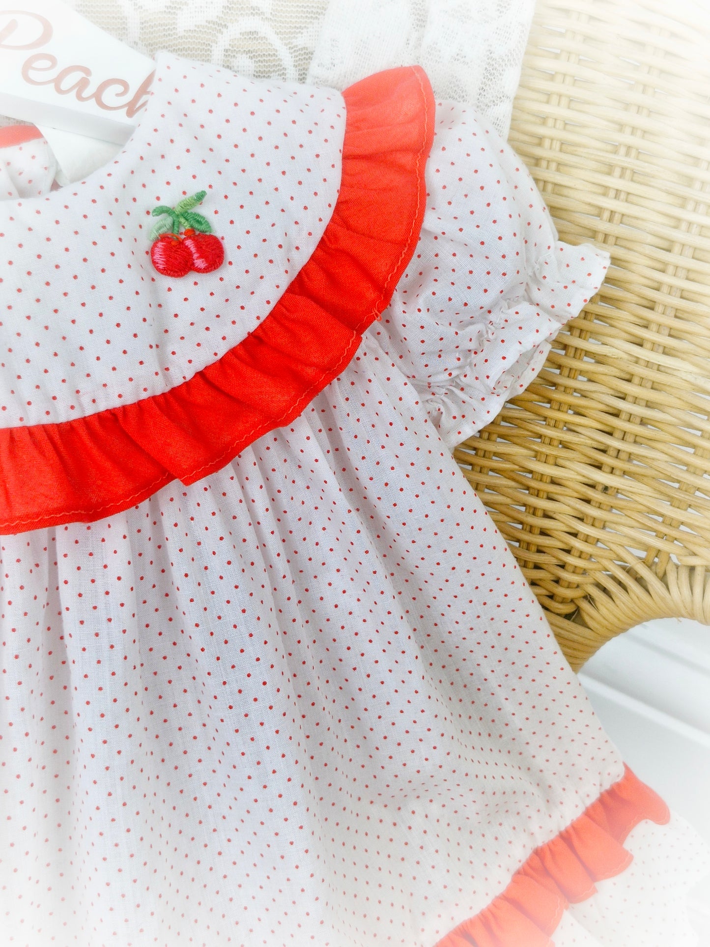 9-12 months. White with red polka dot vintage dress from Kiddie Korner, red frills and cherry applique