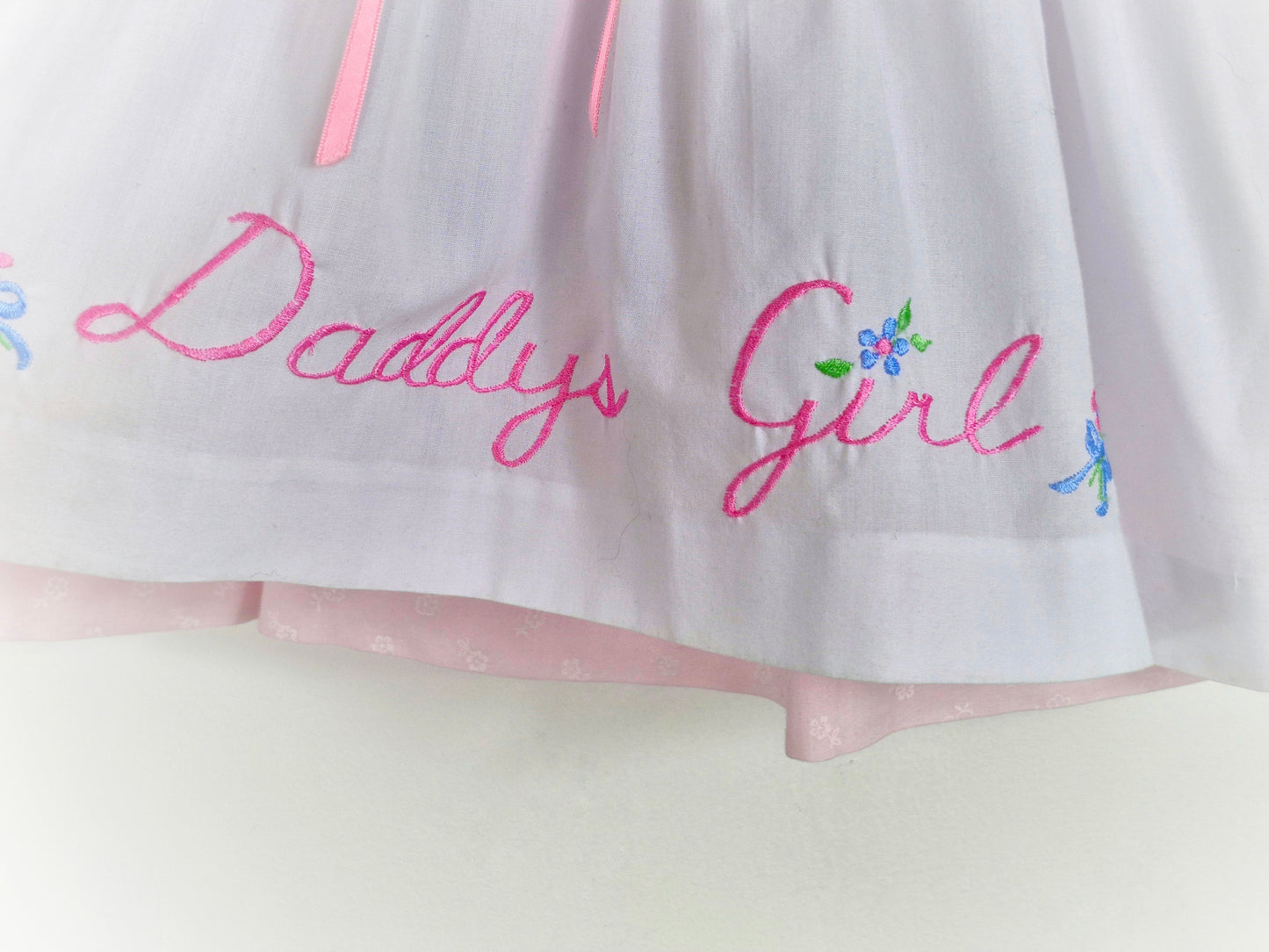 12-18 months. Two piece, pink long sleeve dress with white pinny, embroidered "Daddy's Girl"