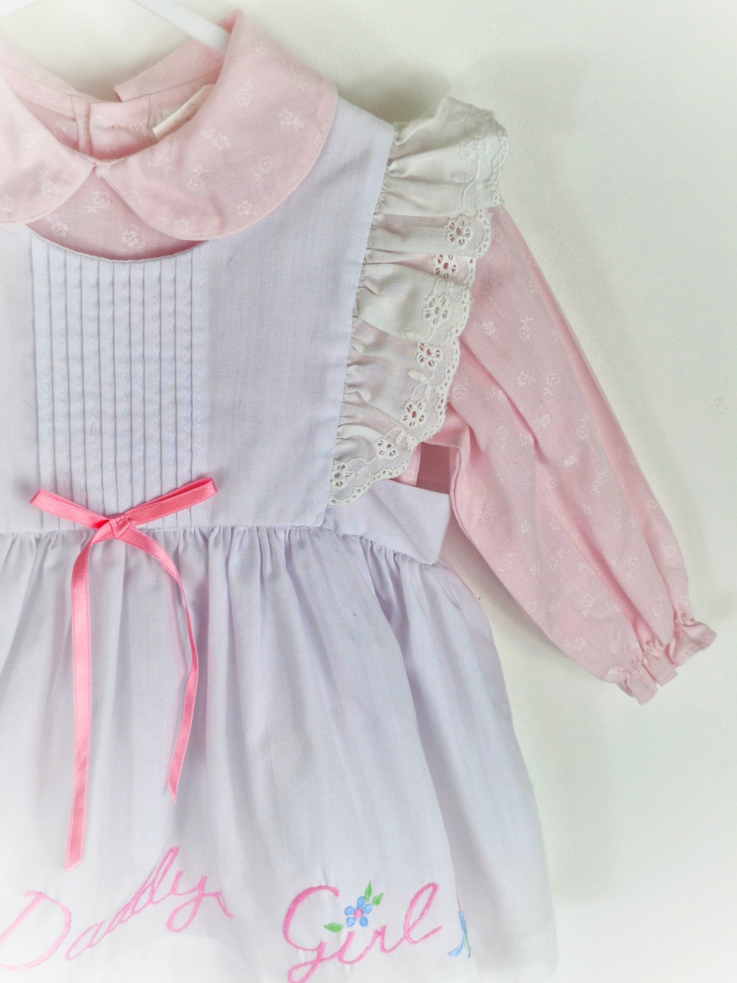 12-18 months. Two piece, pink long sleeve dress with white pinny, embroidered "Daddy's Girl"