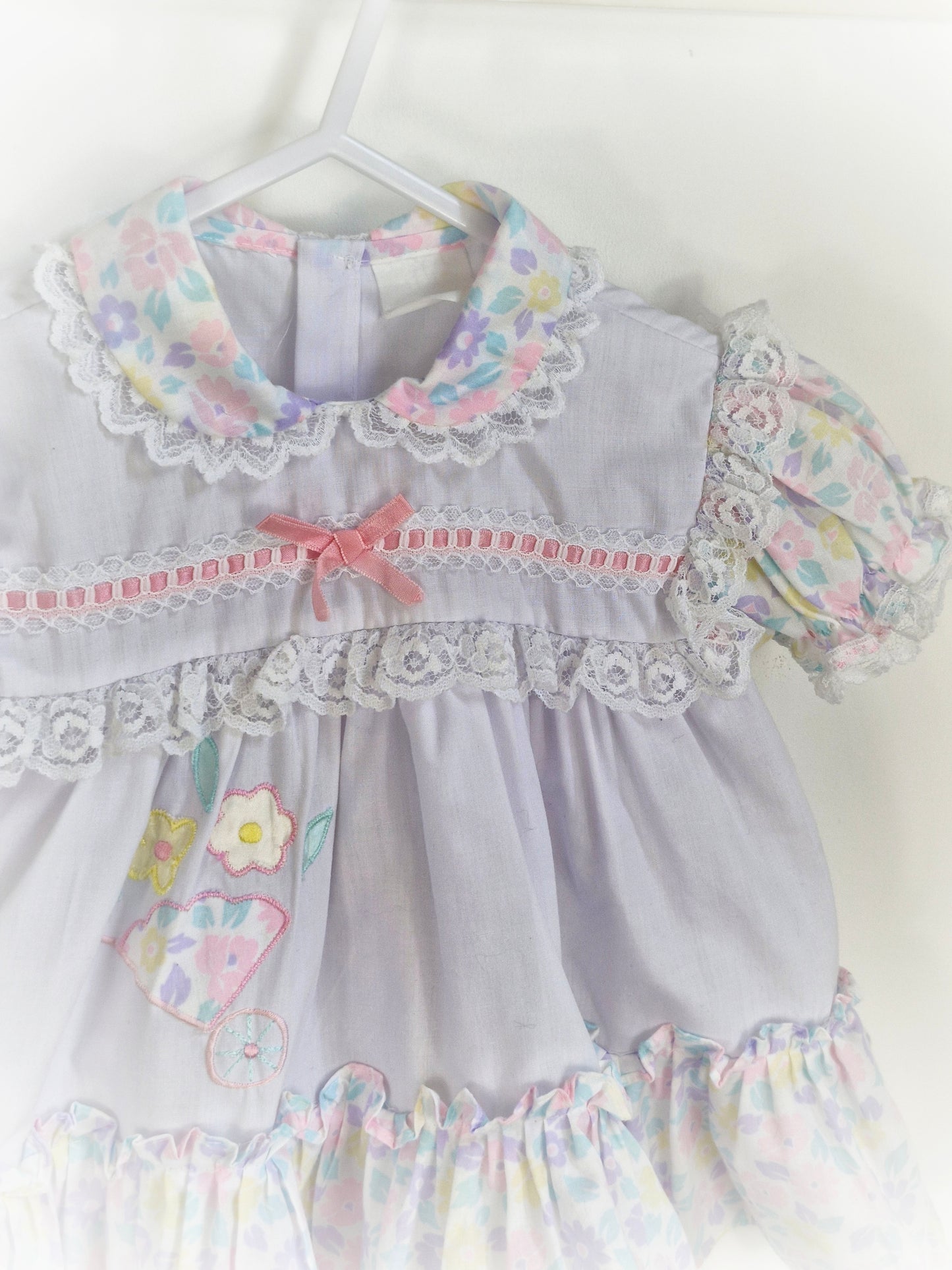 9-12 months. White frilly vintage dress with pastel flowers, ribbon and lace