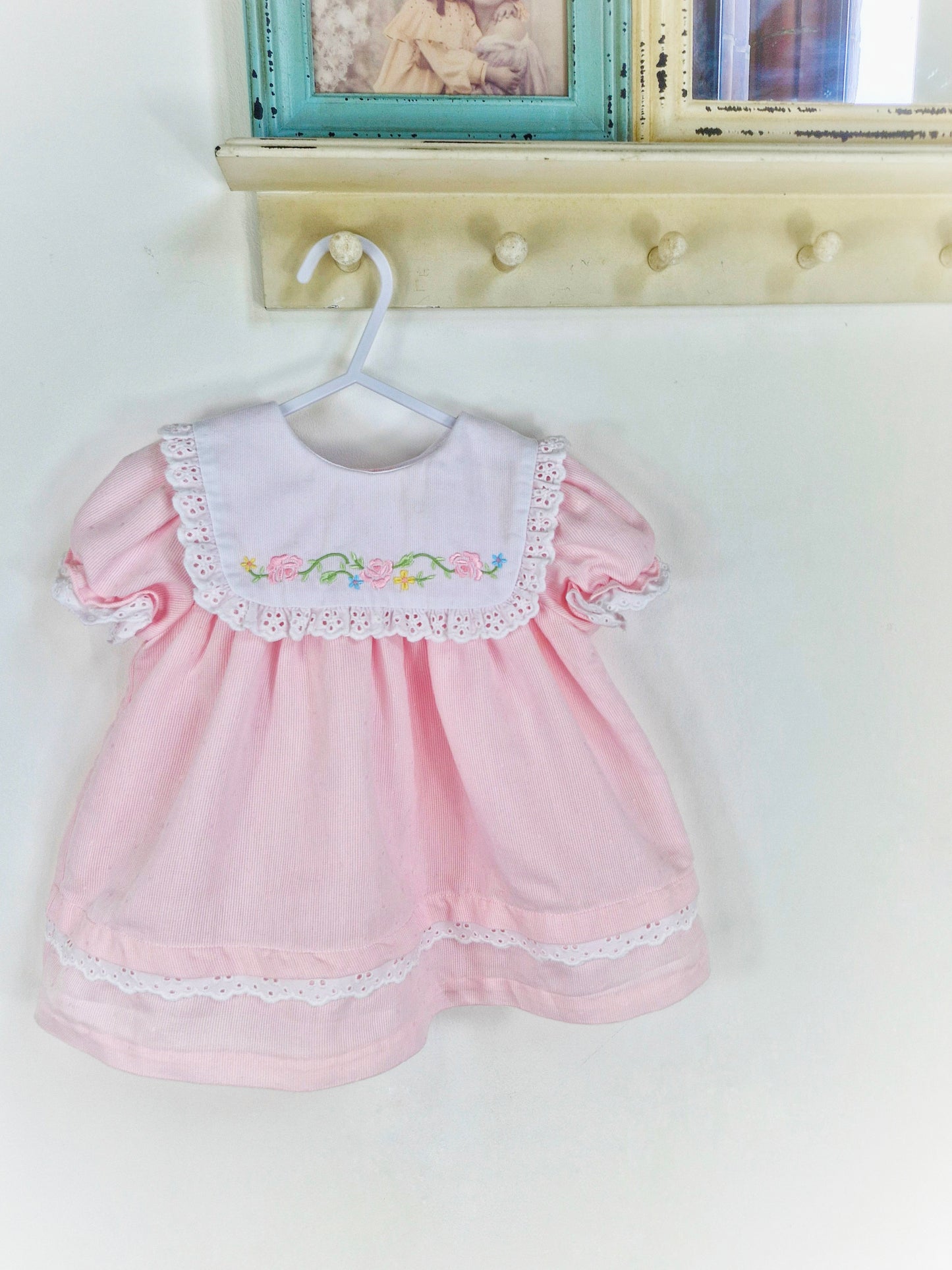 12-18 months. Pink dress with white bib, embroidered with flowers