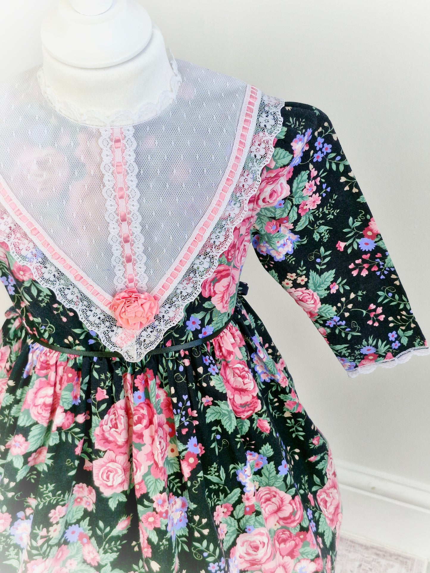 4 years. Black Cuddle Teen vintage dress with pink floral details, white lace bib and pink ribbon