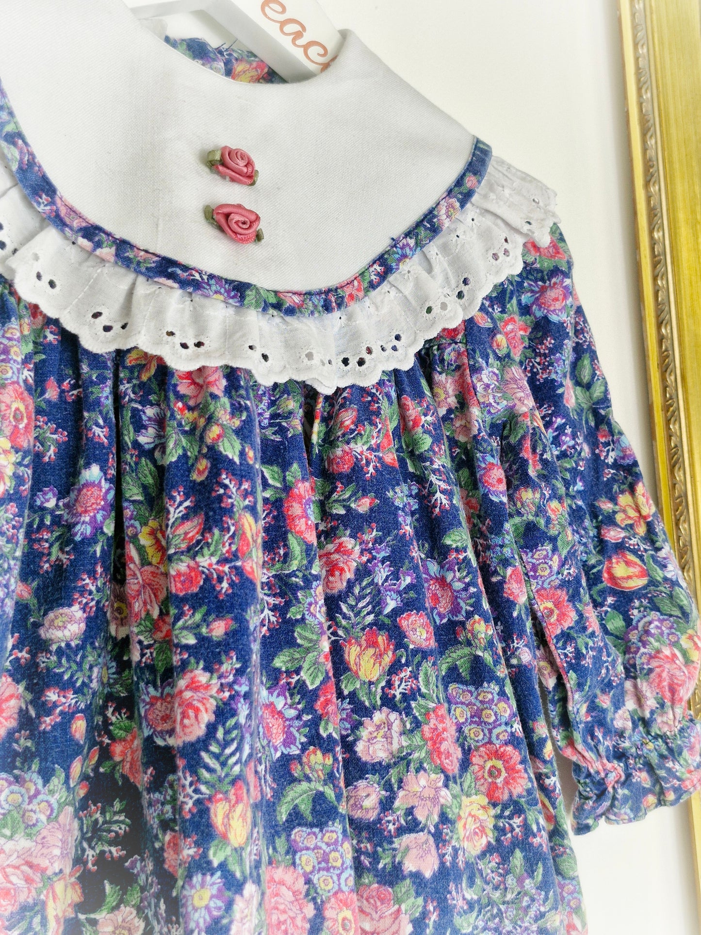 12-18 months. Navy floral vintage dress from BB Club with white broderie anglais bib and hem