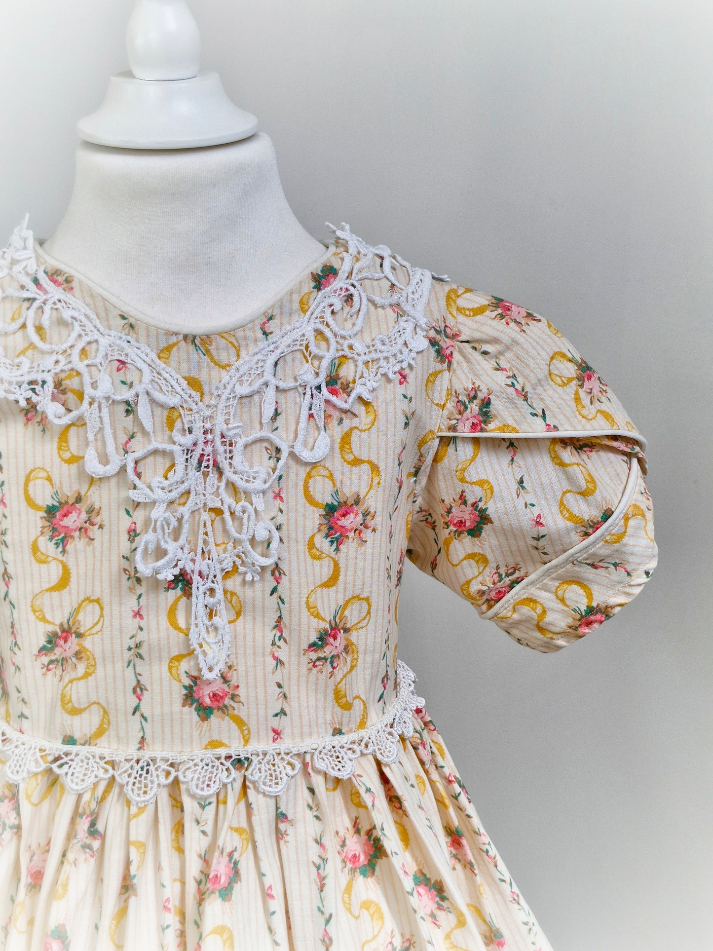 6 years. Handmade, victorian style, puff sleeves, lace trim neckline. Striped dress with floral bouquets