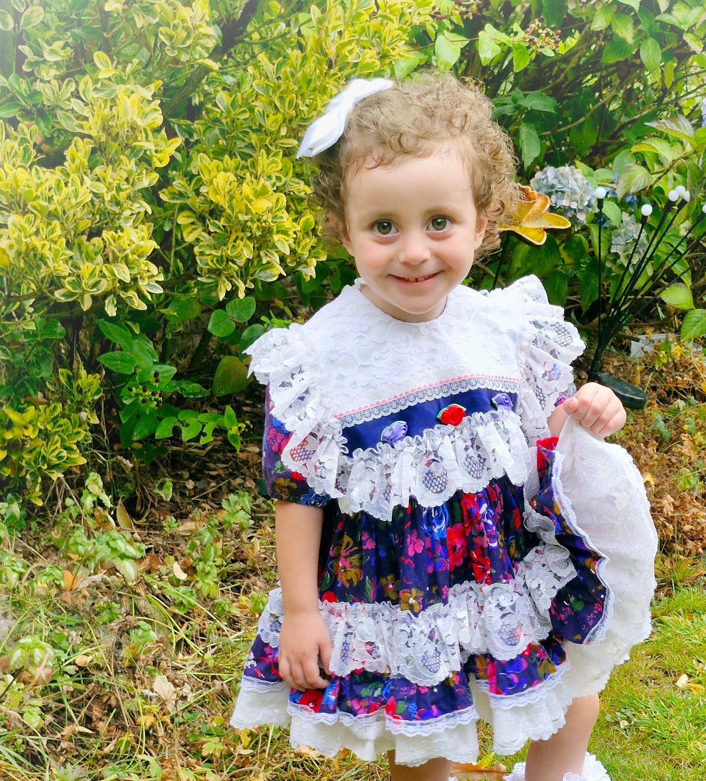 2-3 years. Kotton Kandi floral dress, navy with rosettes and lots of lace