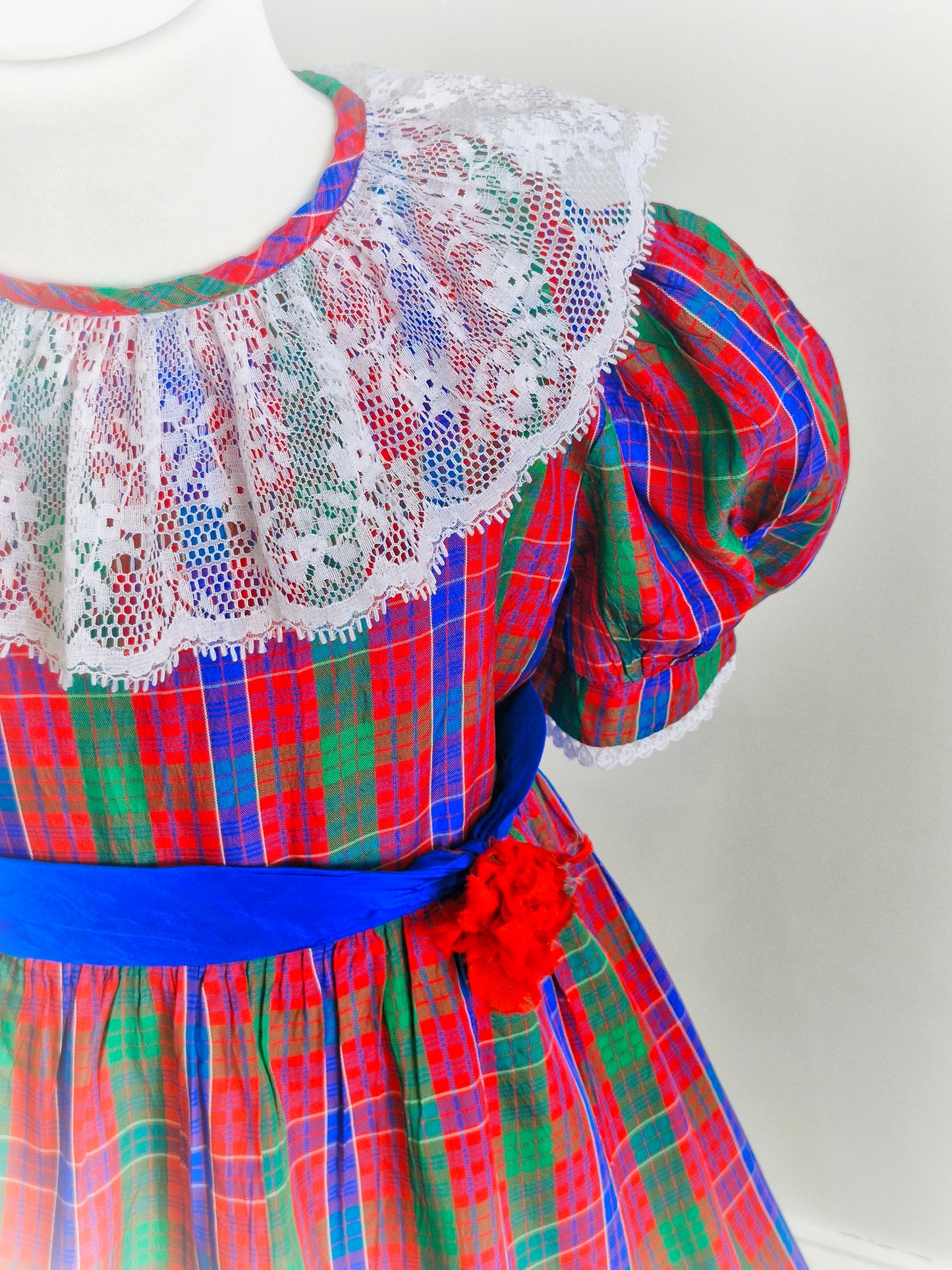6 years. Red, blue and green Youngland tartan dress with white lace bib and hem