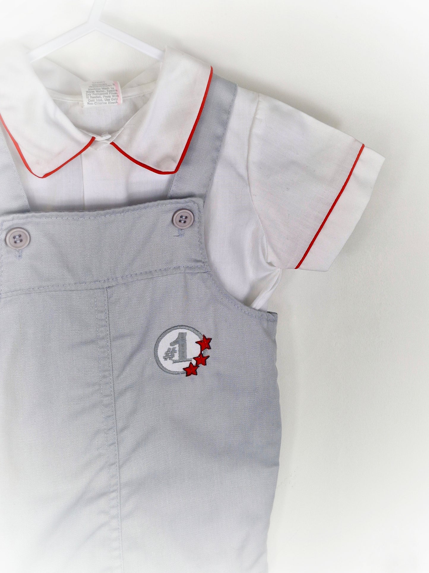 18-24 months. Two piece set, white shirt with red trim and grey dungarees