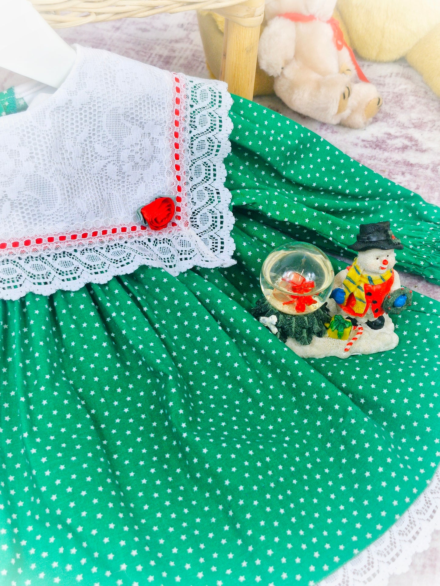 9-12 months. Green vintage Bryan with star print, white lace bib and red details