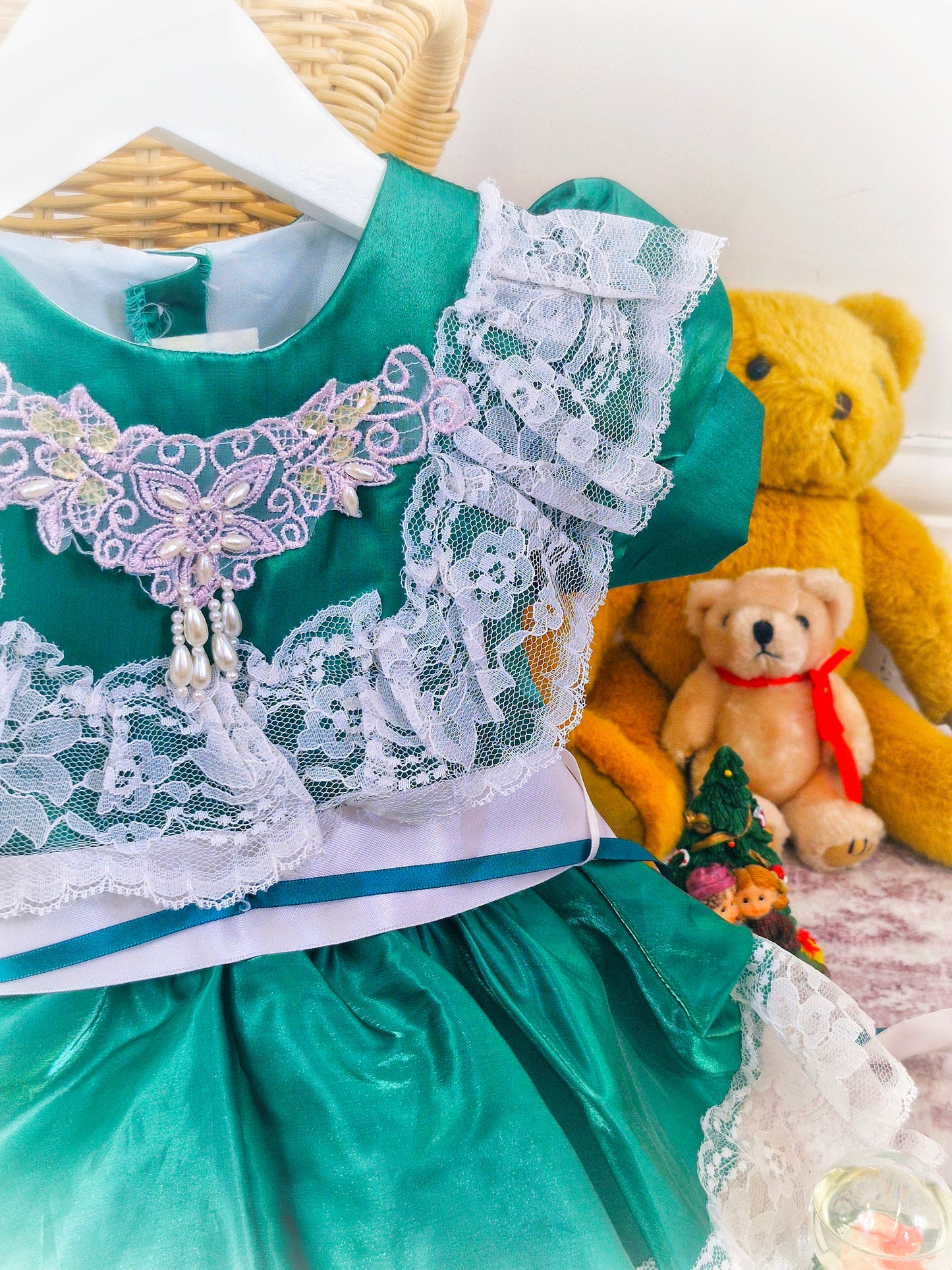 12-18 months. Green satin dress with white lace and ribbon