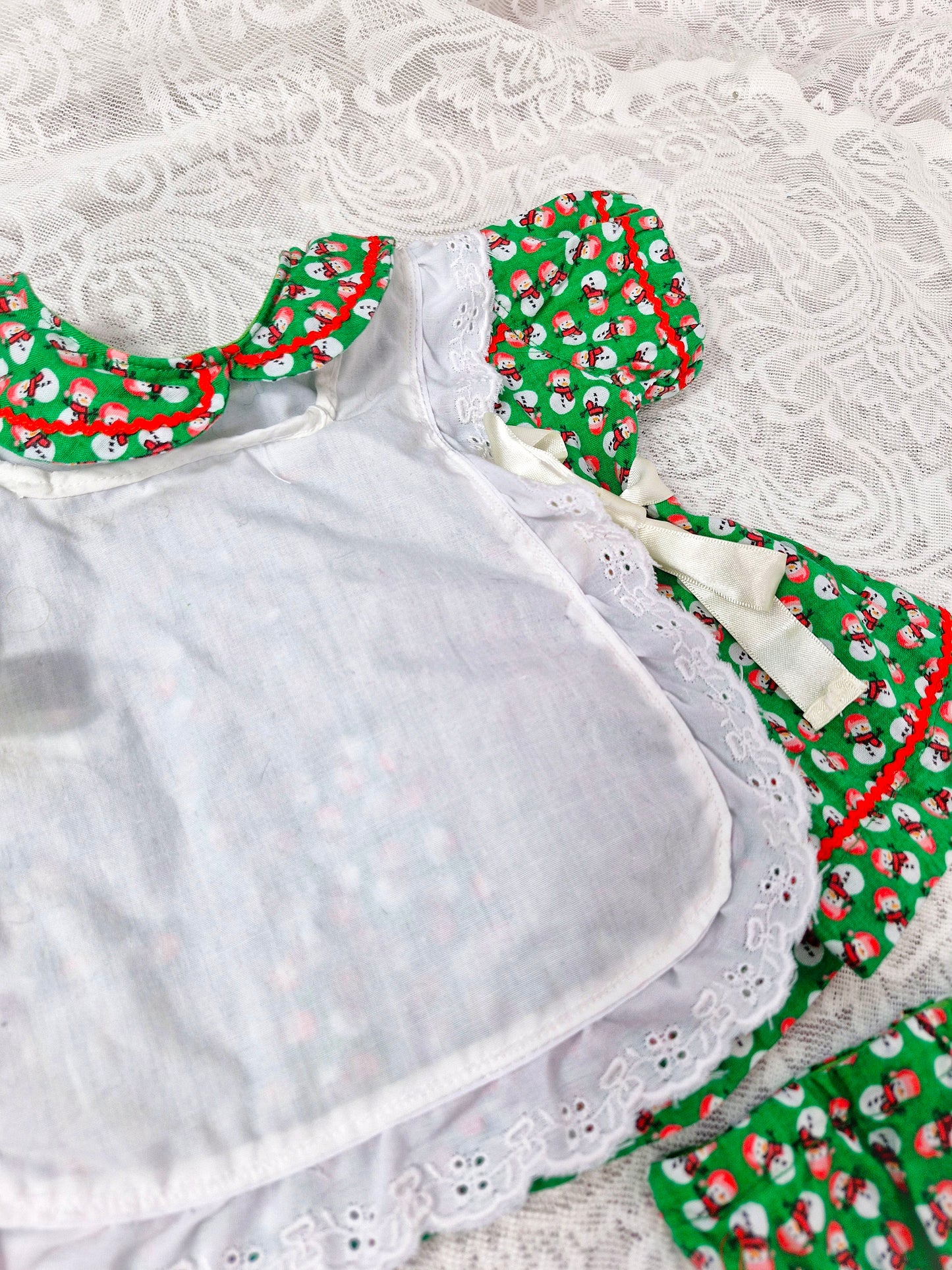 0-3 months. 3 piece set; dress, bloomers and pinny. Green with snowman print. Handmade.
