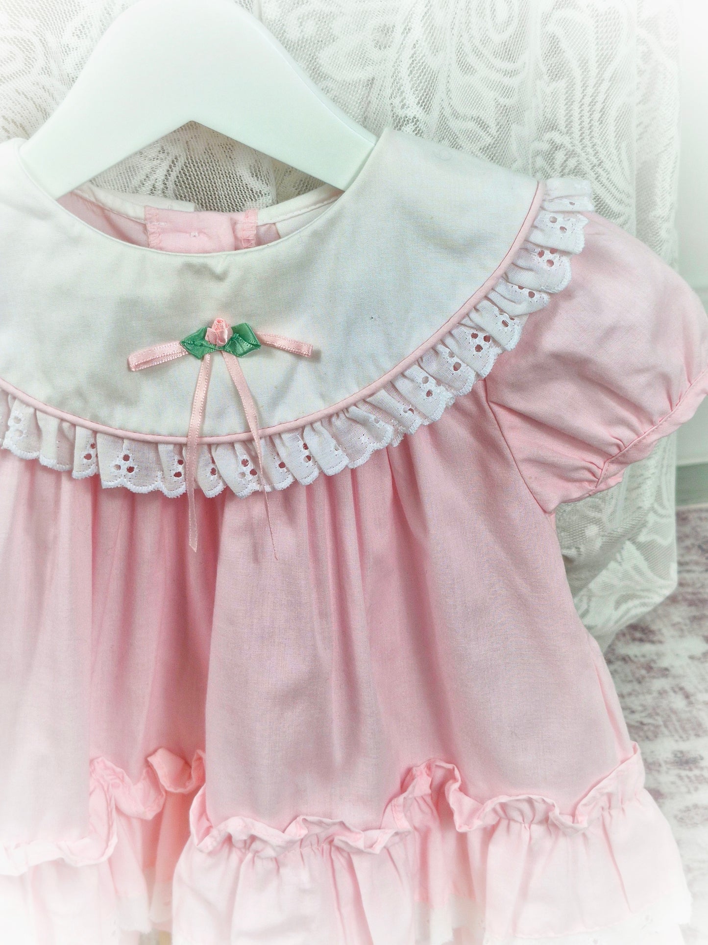 12-18 months. Pink vintage dress from Rose Cottage, white frilly bib and layered hem