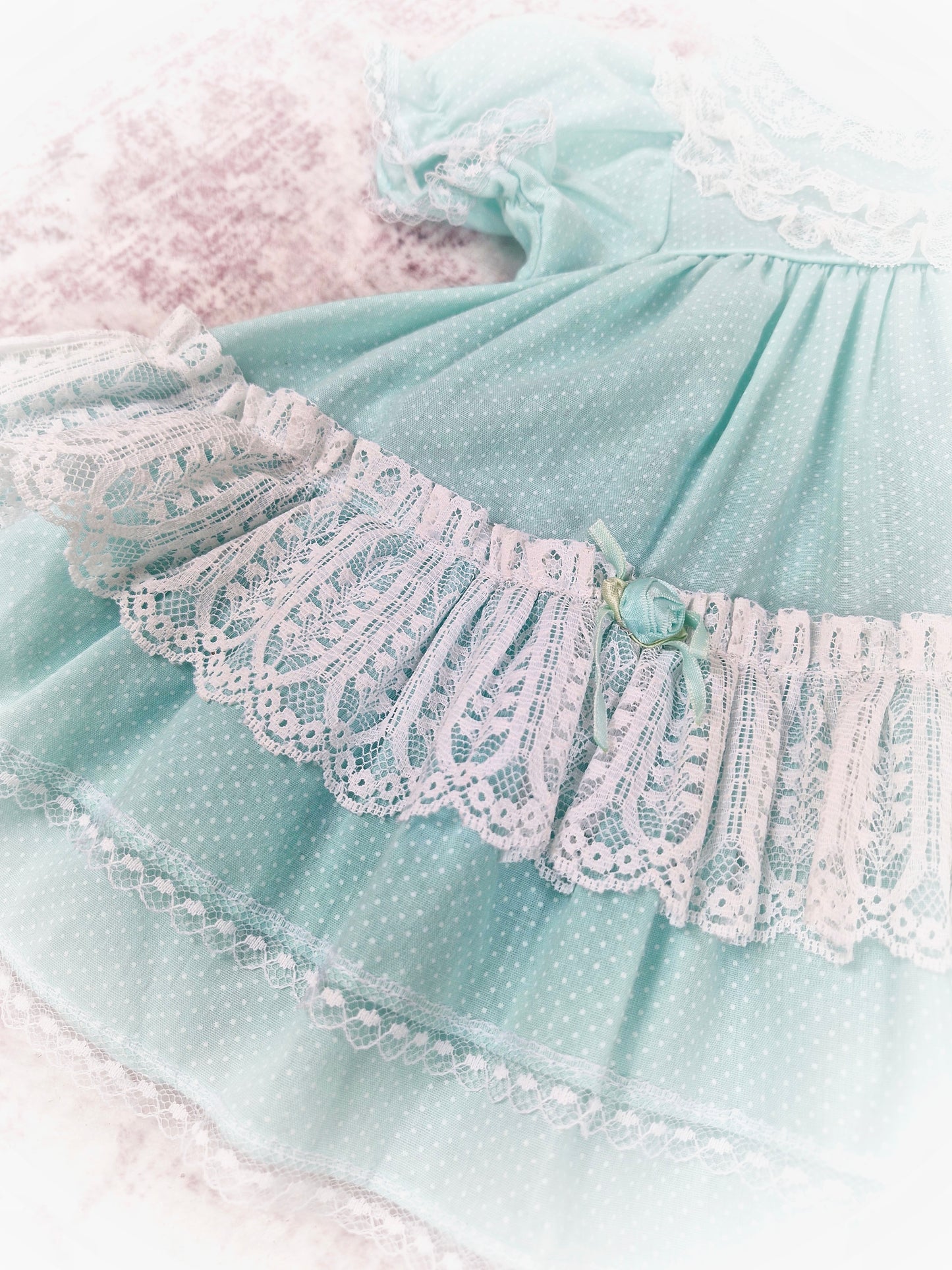 9-12 months. Vintage Petit Jouet, mint dress with white lace and rosettes