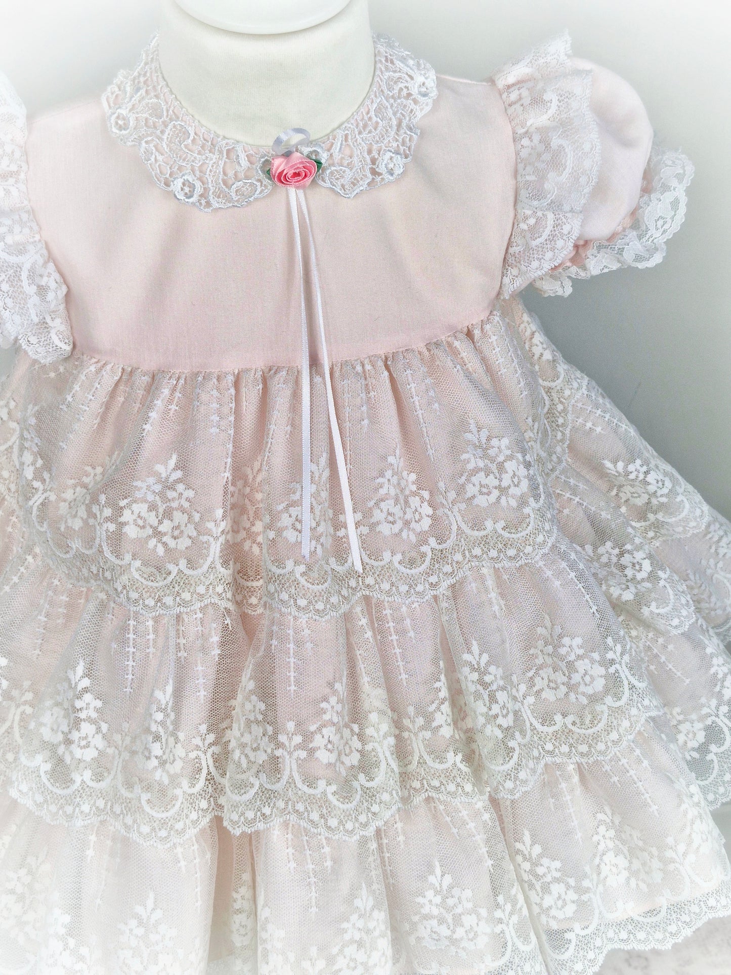 18-24 months. Vintage Jolene, pale pink with white lace layers, flutter puff sleeves and lace collar