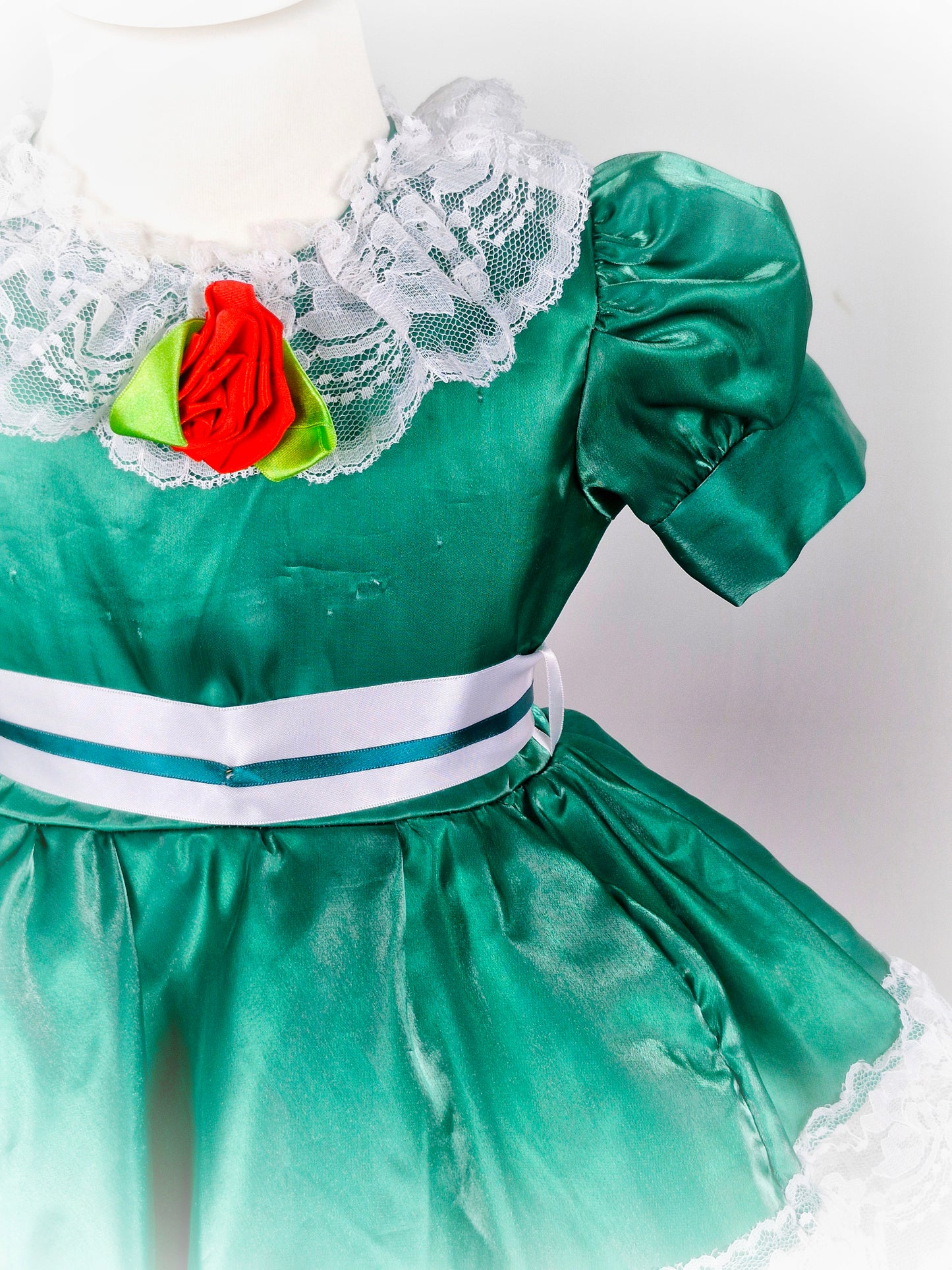 2 years. Green satin dress with white lace and ribbon and red rose. Small pinholes*