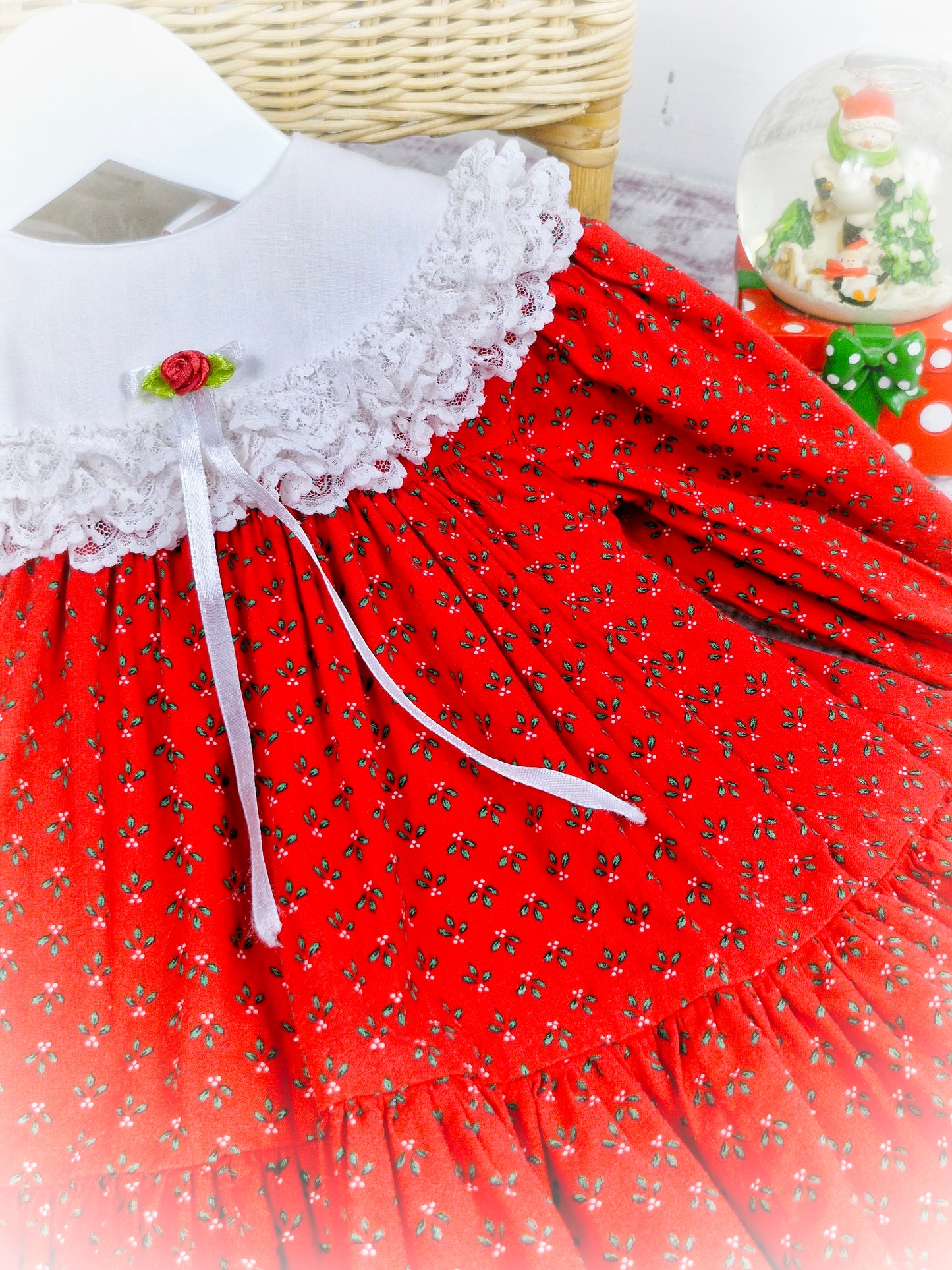 9-12 months. Red vintage Bryan with festive floral print, white Cuddle bib and red rosette