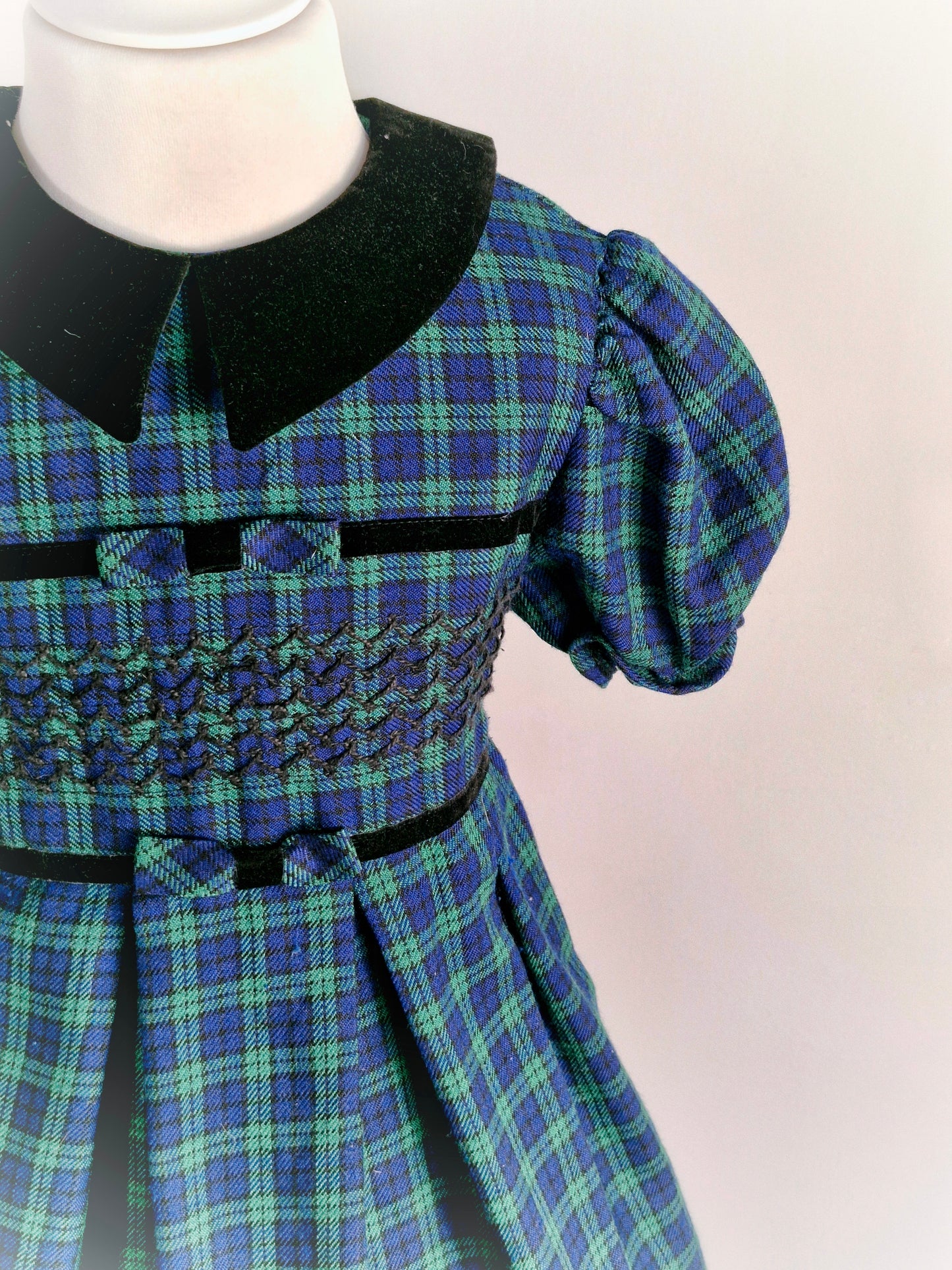 6 years. Bonnie Jean, navy and green tartan dress with black velour collar and smocking