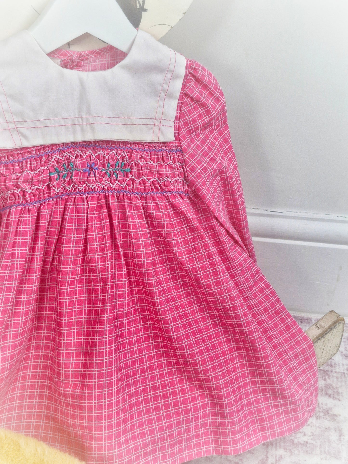 18-24 months. Pink checkered vintage smock dress with long sleeves and white bib
