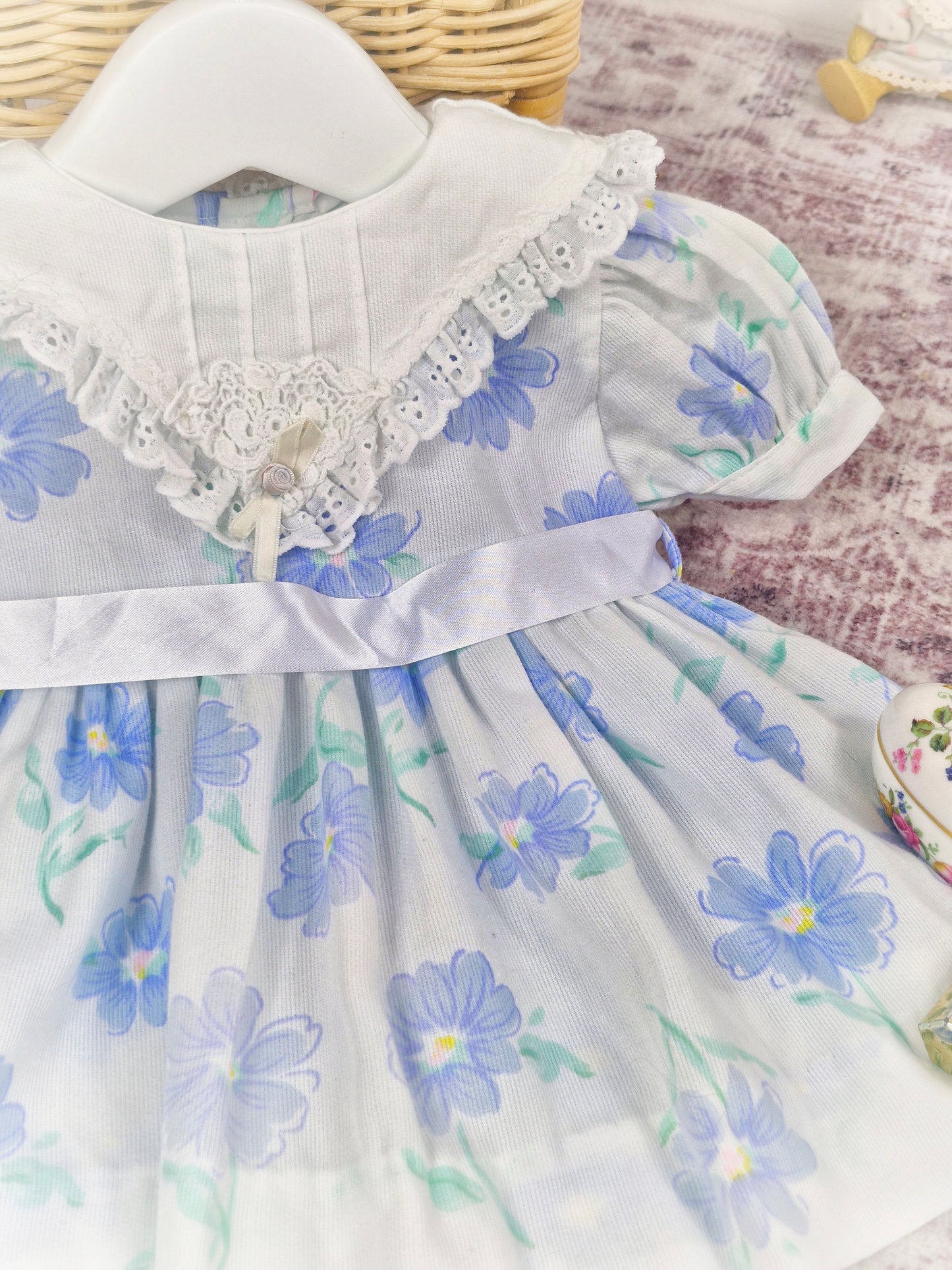 6-9 months. White vintage dress with blue floral patterns, white bib and satin ribbon