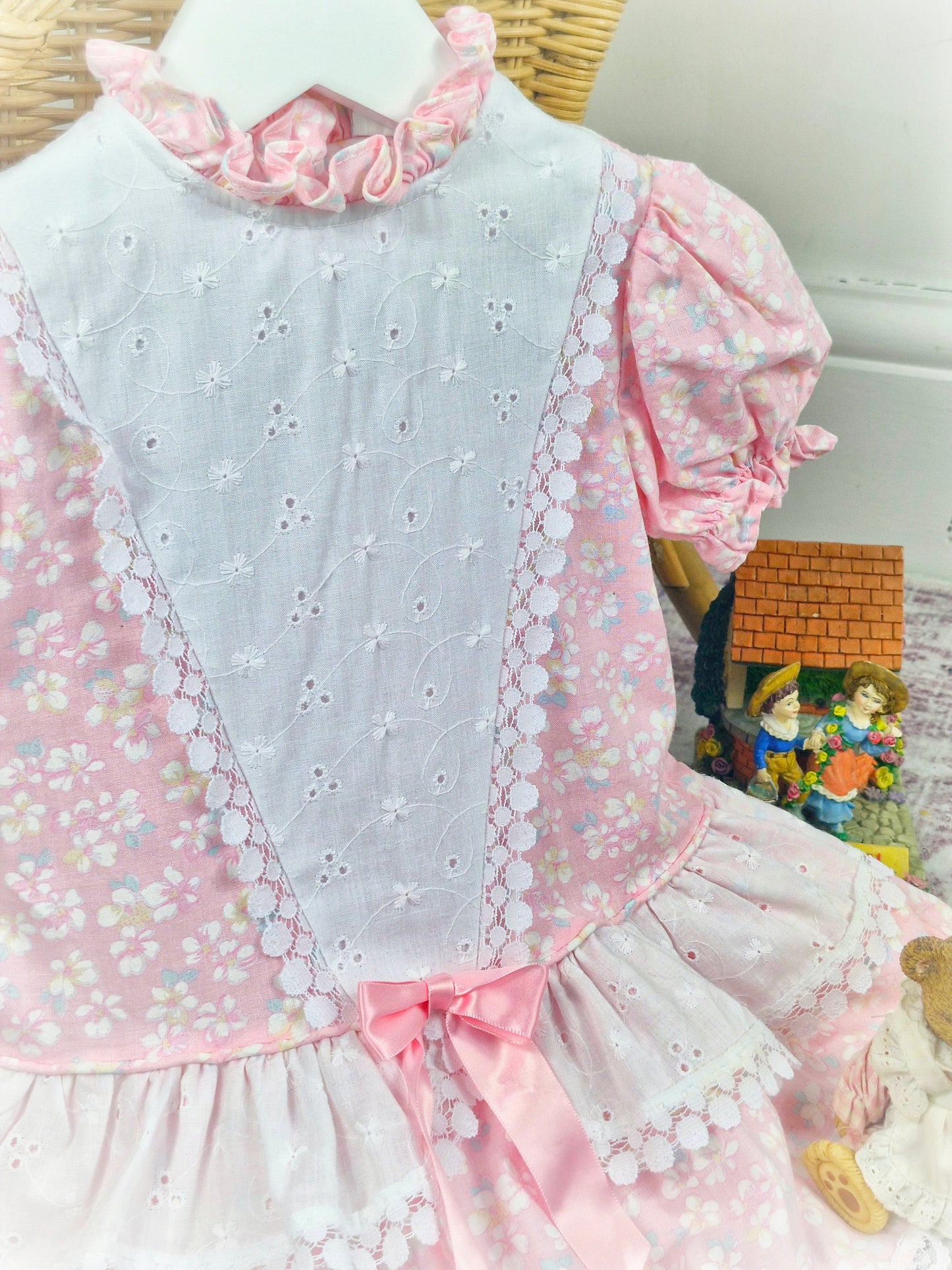 12-18 months. Pink and white vintage floral drop waist dress with frill neck and pink satin ribbon