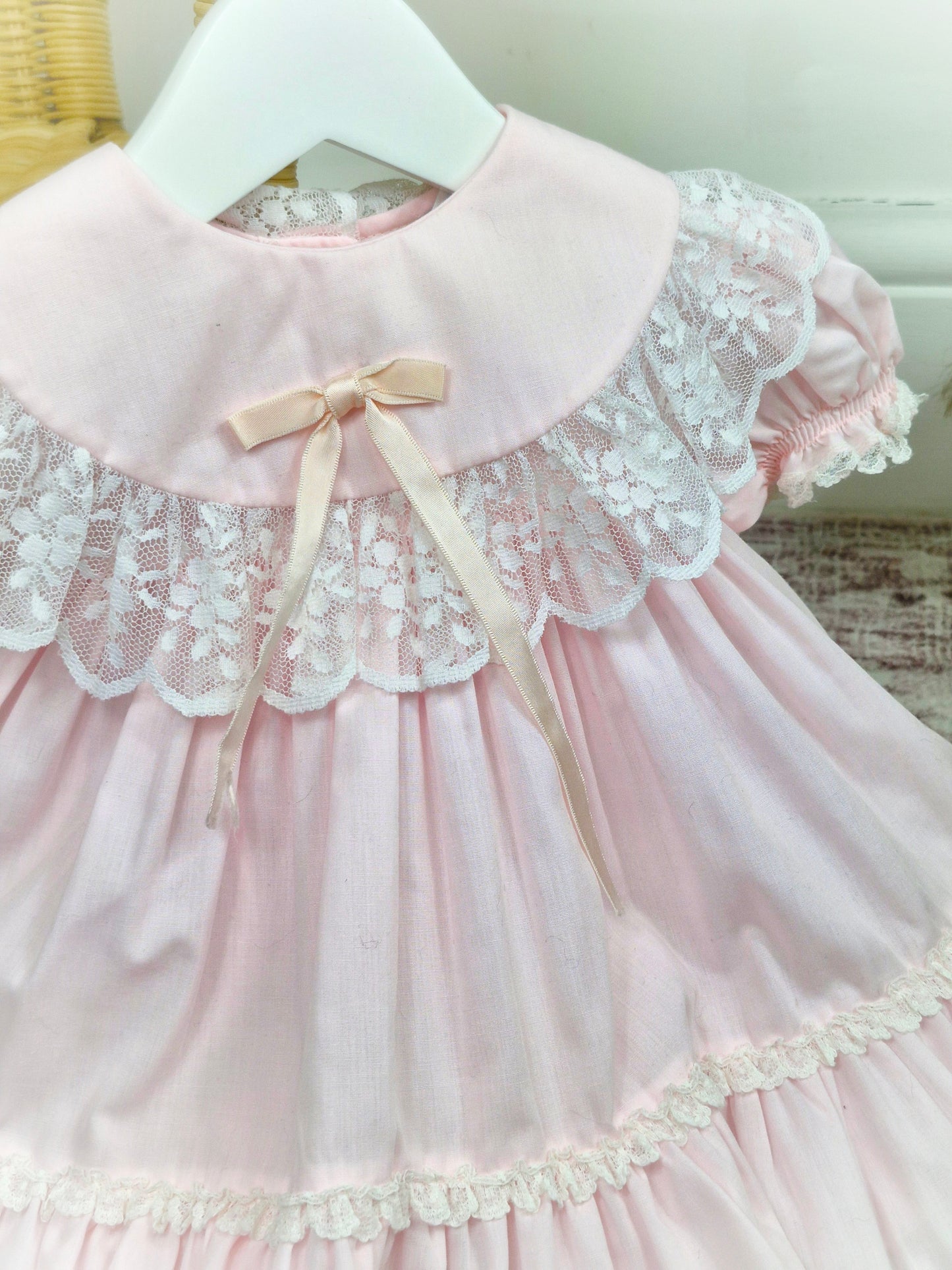 9 months. Pink vintage Bryan with white lace details, puff sleeves and satin bow