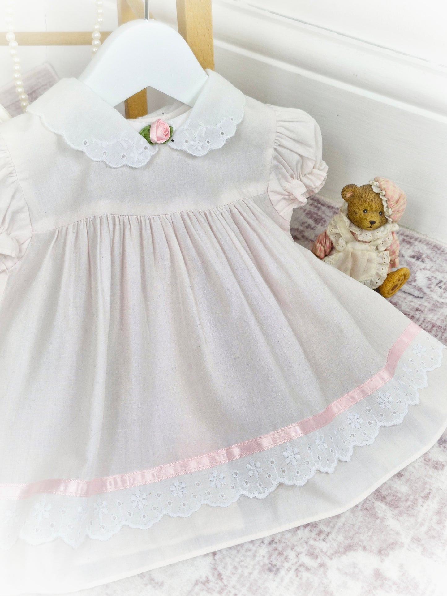 6-9 months. Light pink and white vintage dress from Bright Future with pink rosette and satin ribbon