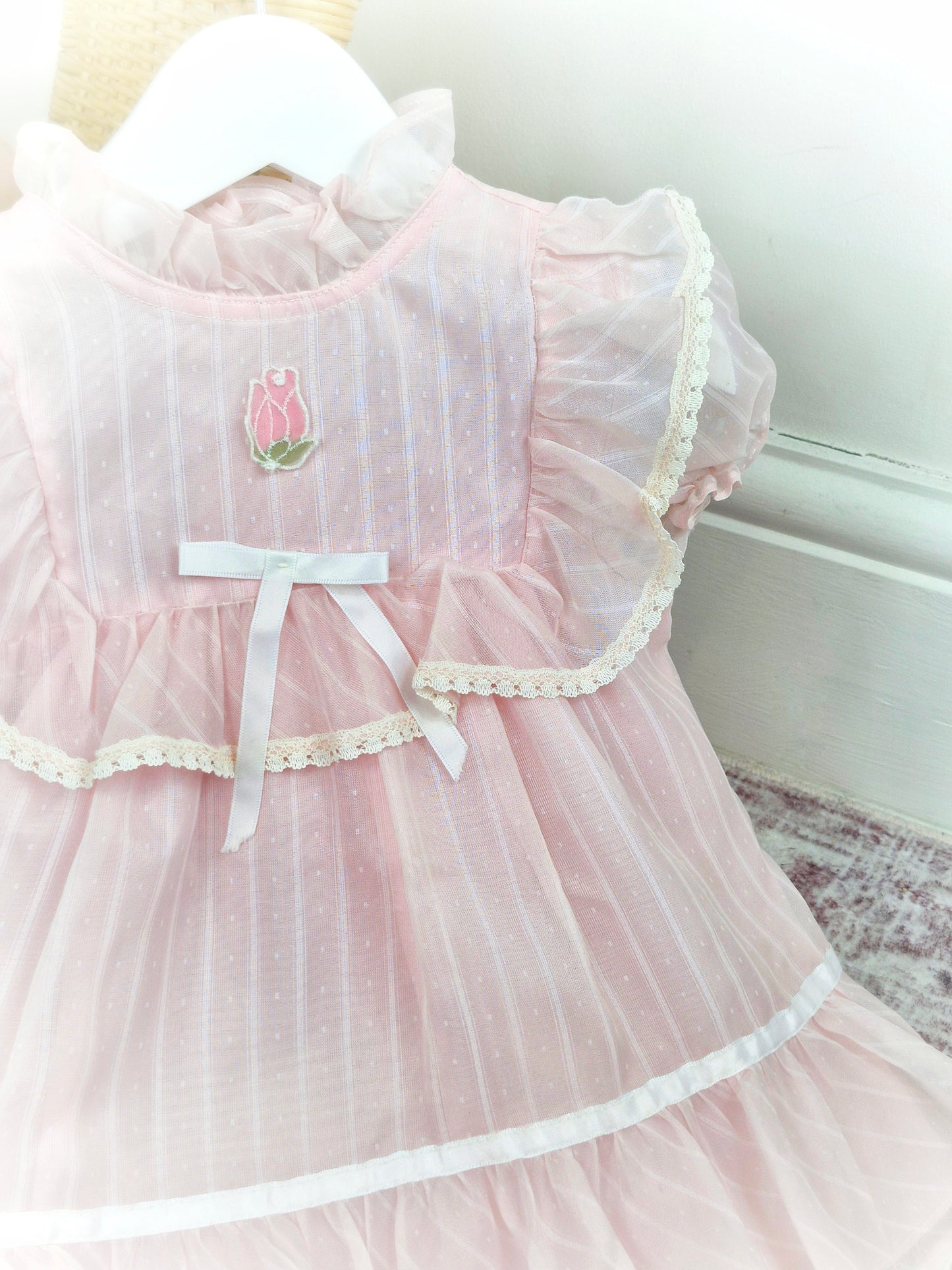 12-18 months. Light pink sheer vintage dress with lace, ruffles and white satin bow