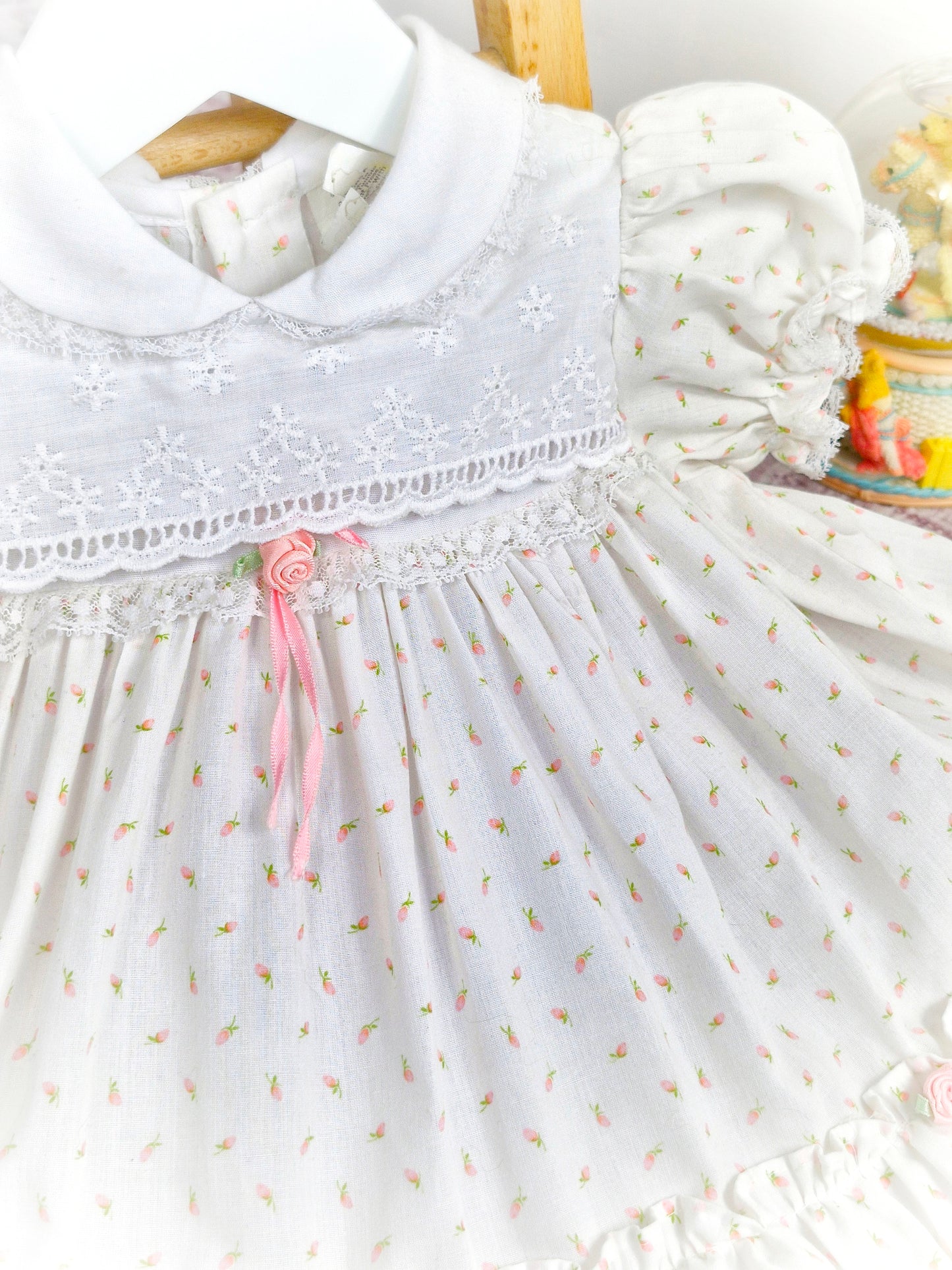 12-18 months. White vintage dress with pink floral print, rosettes and ribbon, puff sleeves and embroidered chest