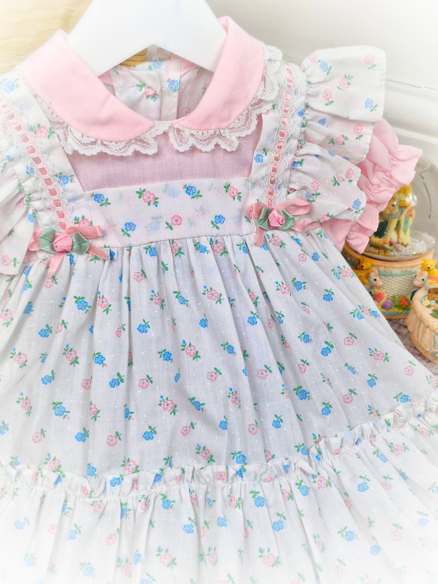 12 months. Pink and white vintage floral dress with ruffles, frills, ribbon and rosettes