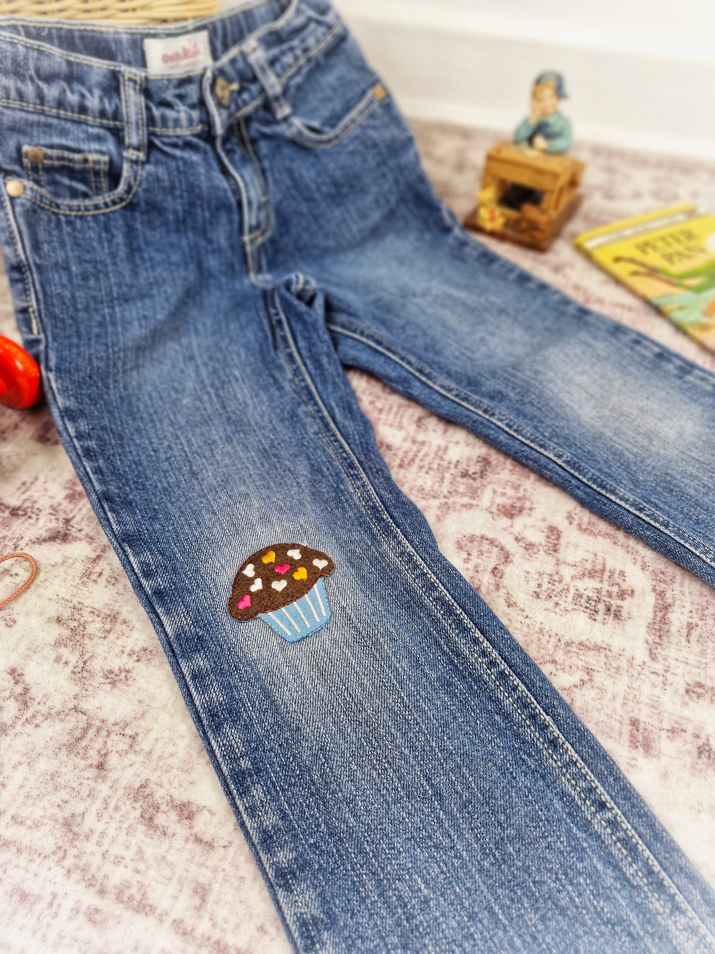 5 years. Oshkosh jeans with cupcake applique on the knee