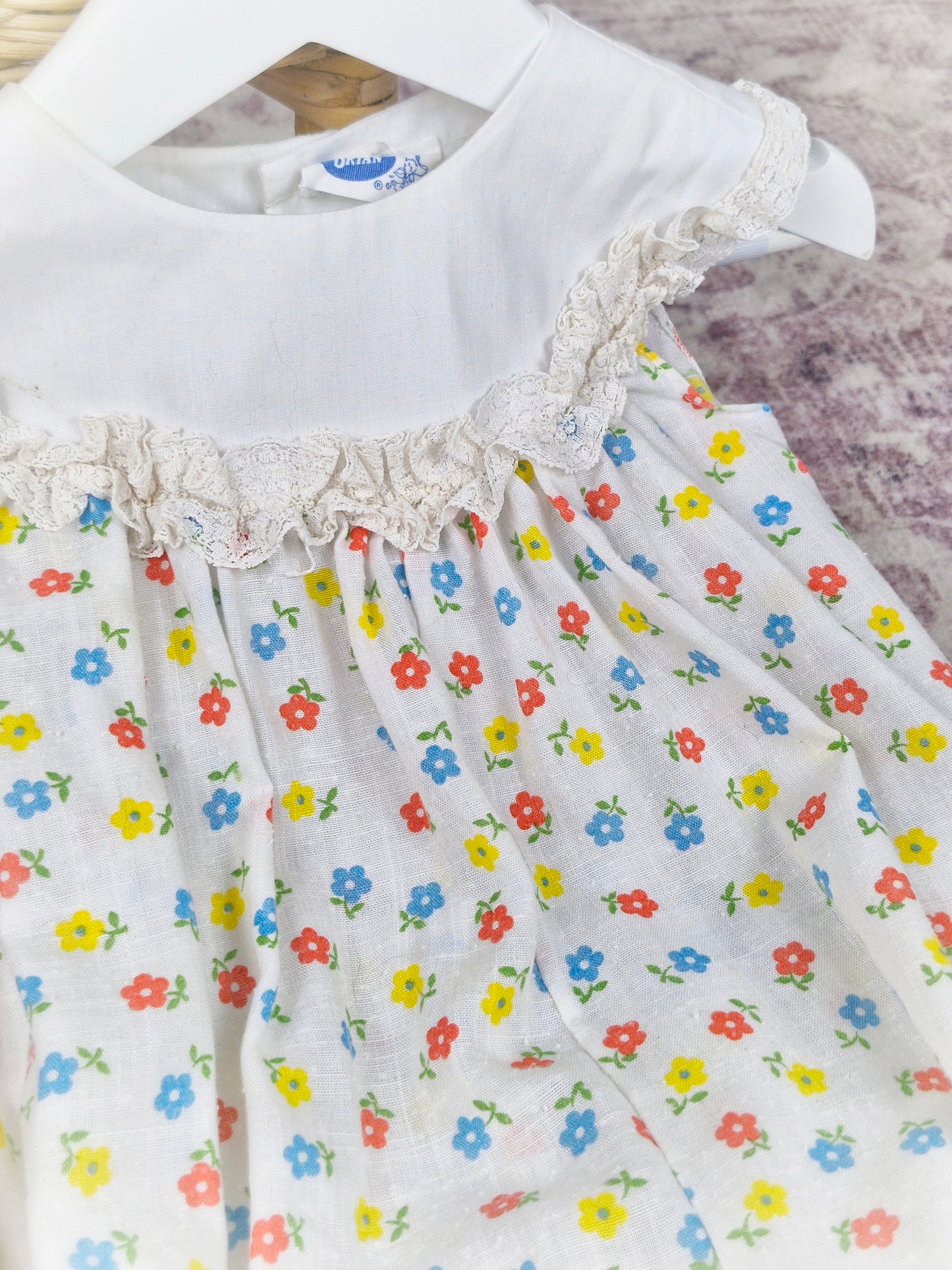 9-12 months. White vintage Bryan romper with floral print and white bib