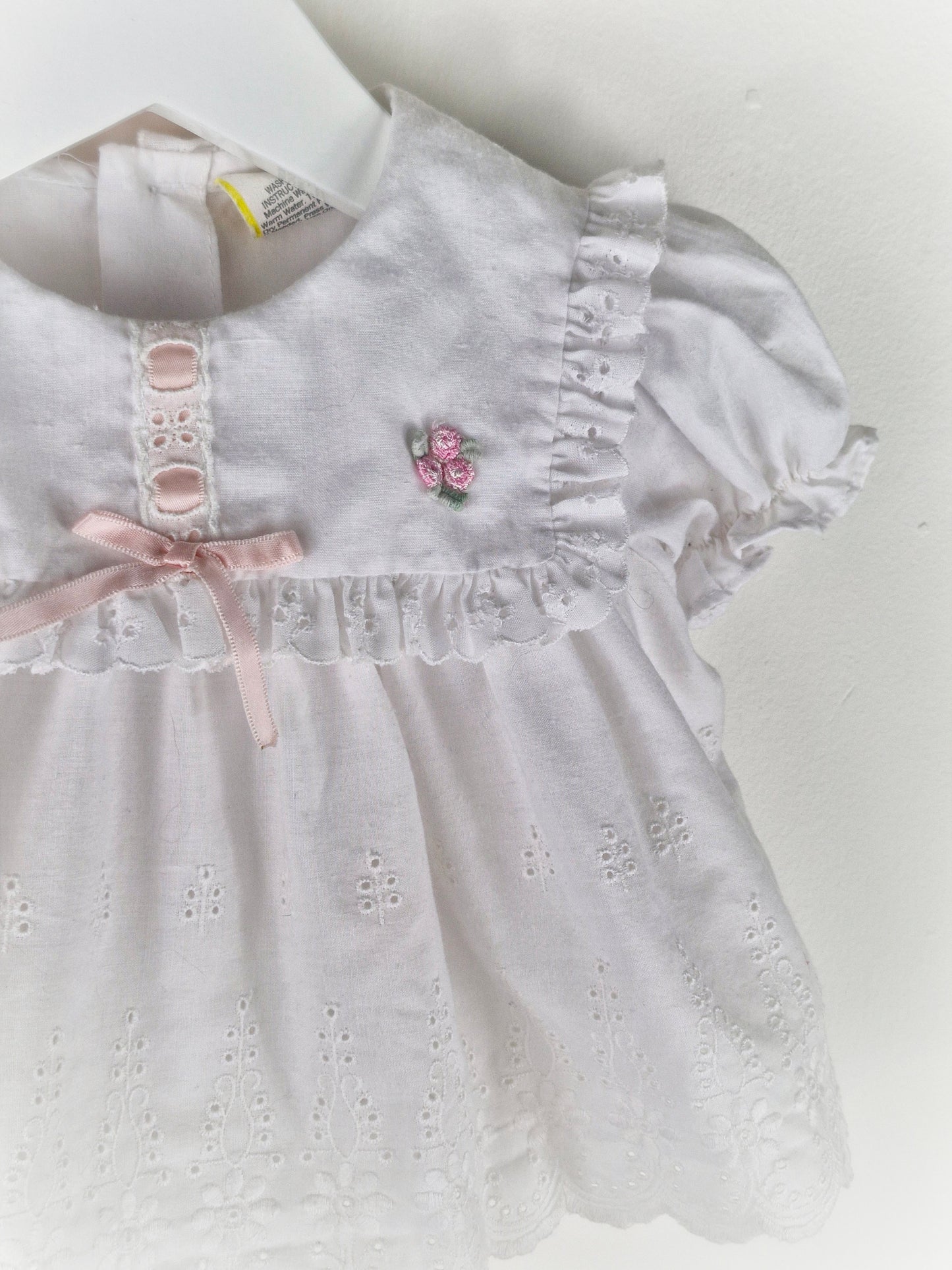 0-6 months. White vintage broderie anglais dress with pink satin ribbon